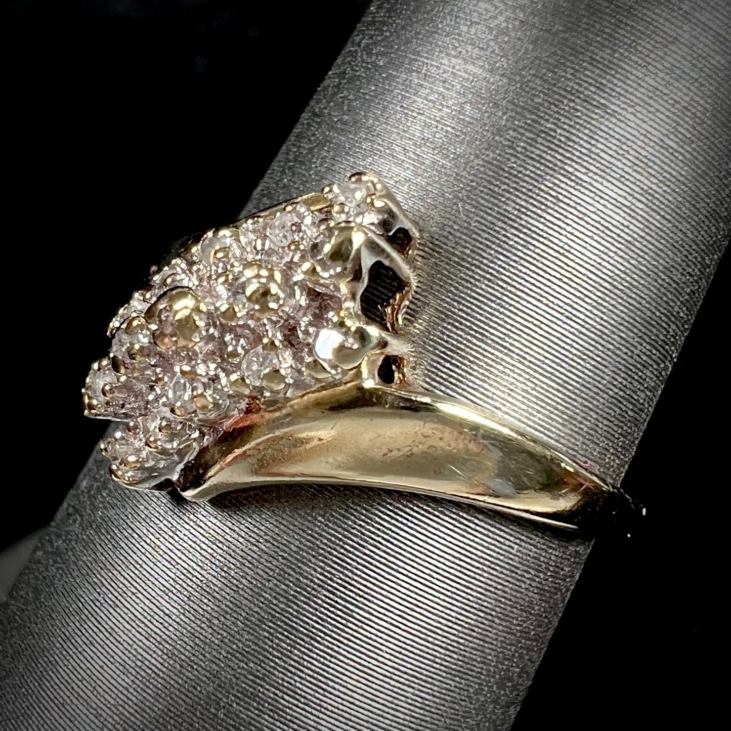 A ladies' estate yellow gold diamond cluster ring. The diamonds are round single cuts.