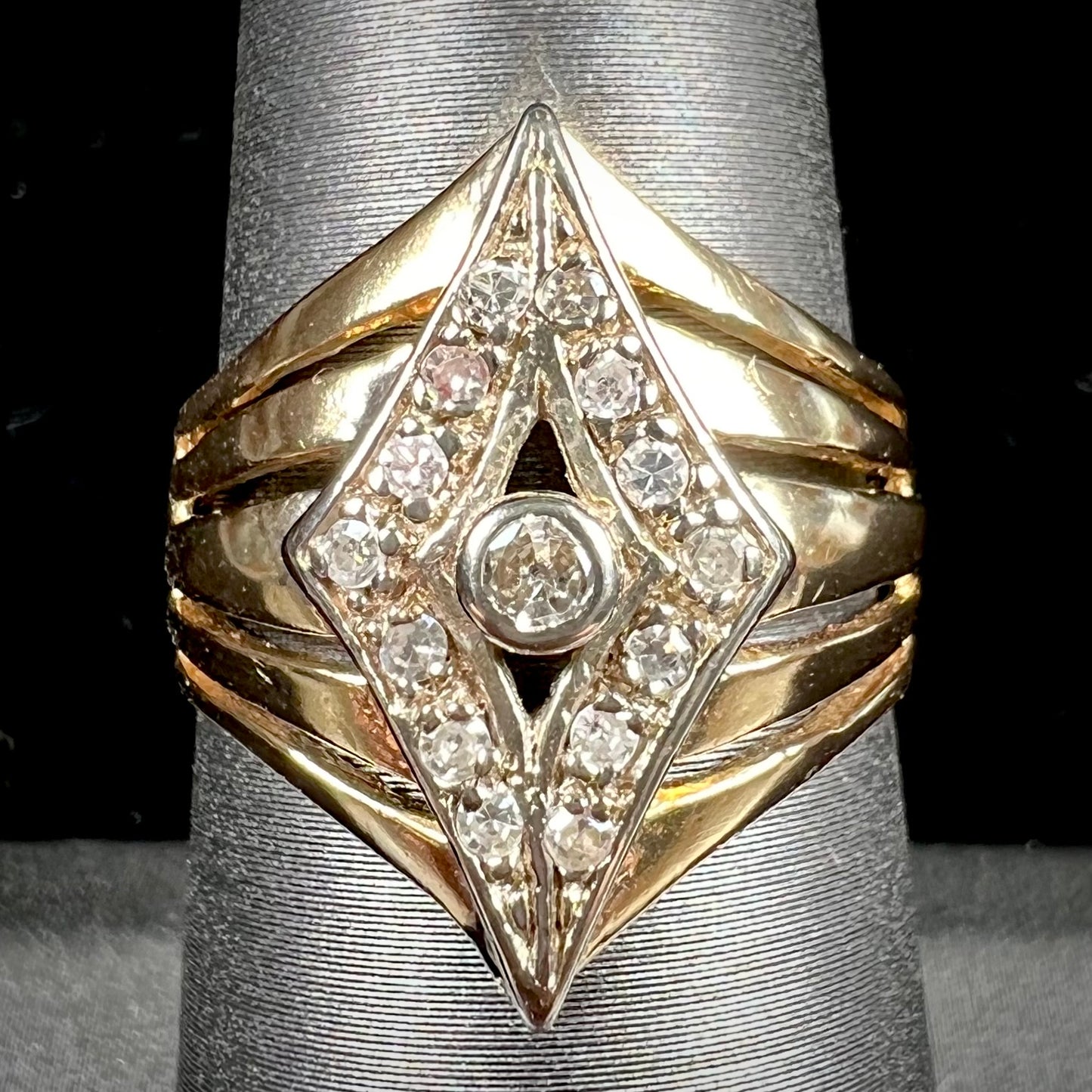 An estate ladies' gold diamond ring. The shape of the ring resembles an art deco style diamond.