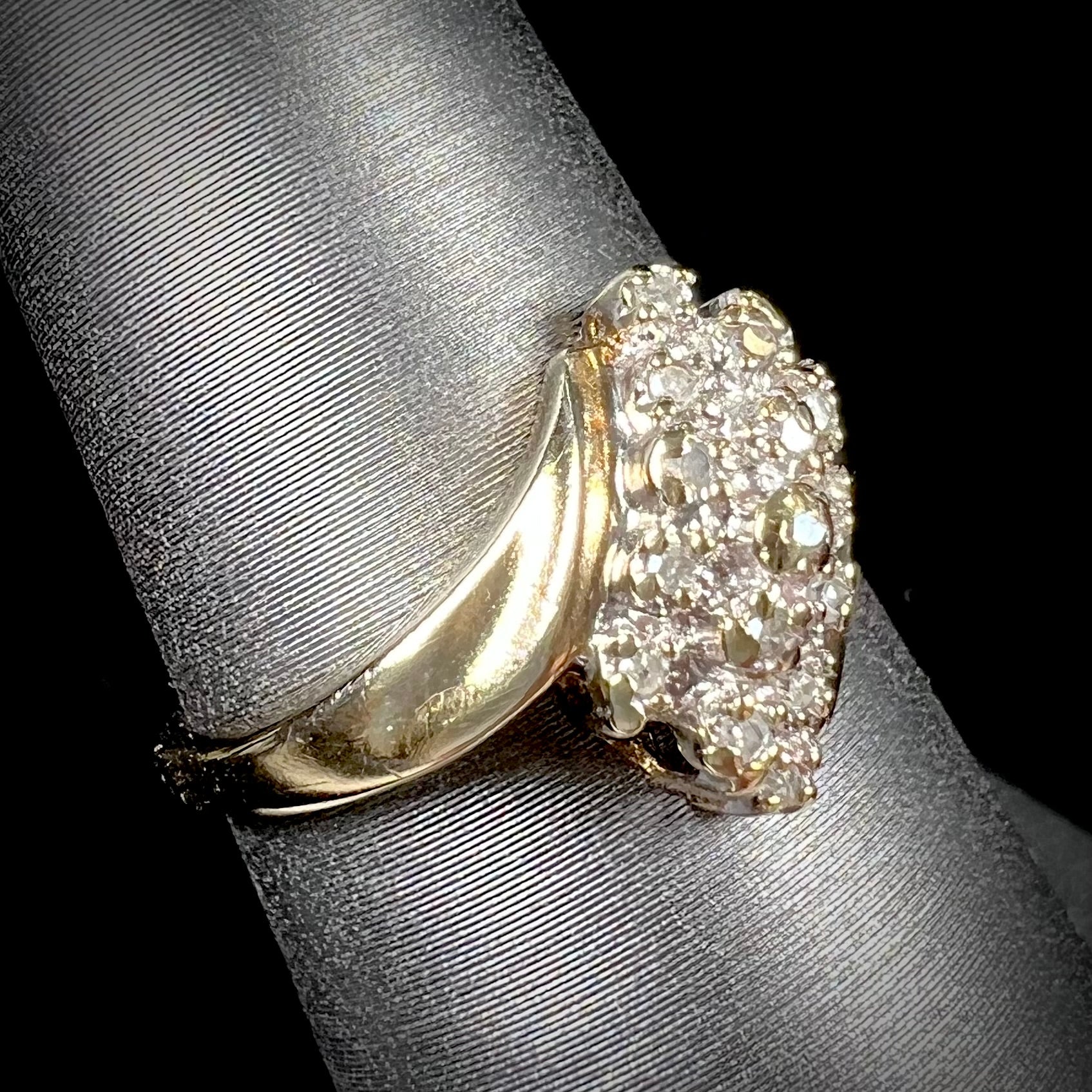 A ladies' estate yellow gold diamond cluster ring.  The diamonds are round single cuts.