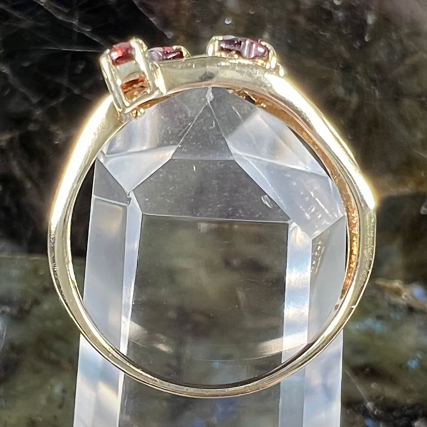 A yellow gold multishank ring set with two heart shape and two round cut red garnets.