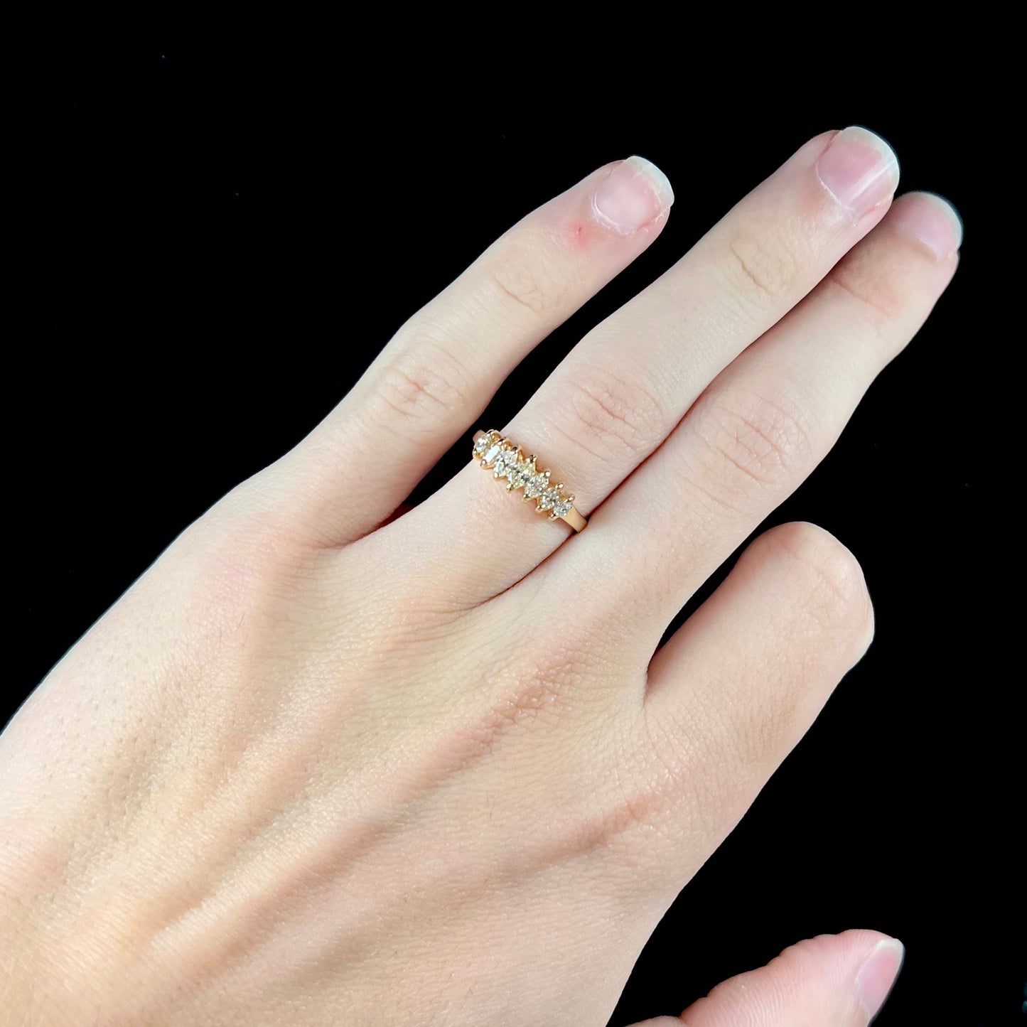 An estate yellow gold ring prong set with seven marquise cut diamonds.