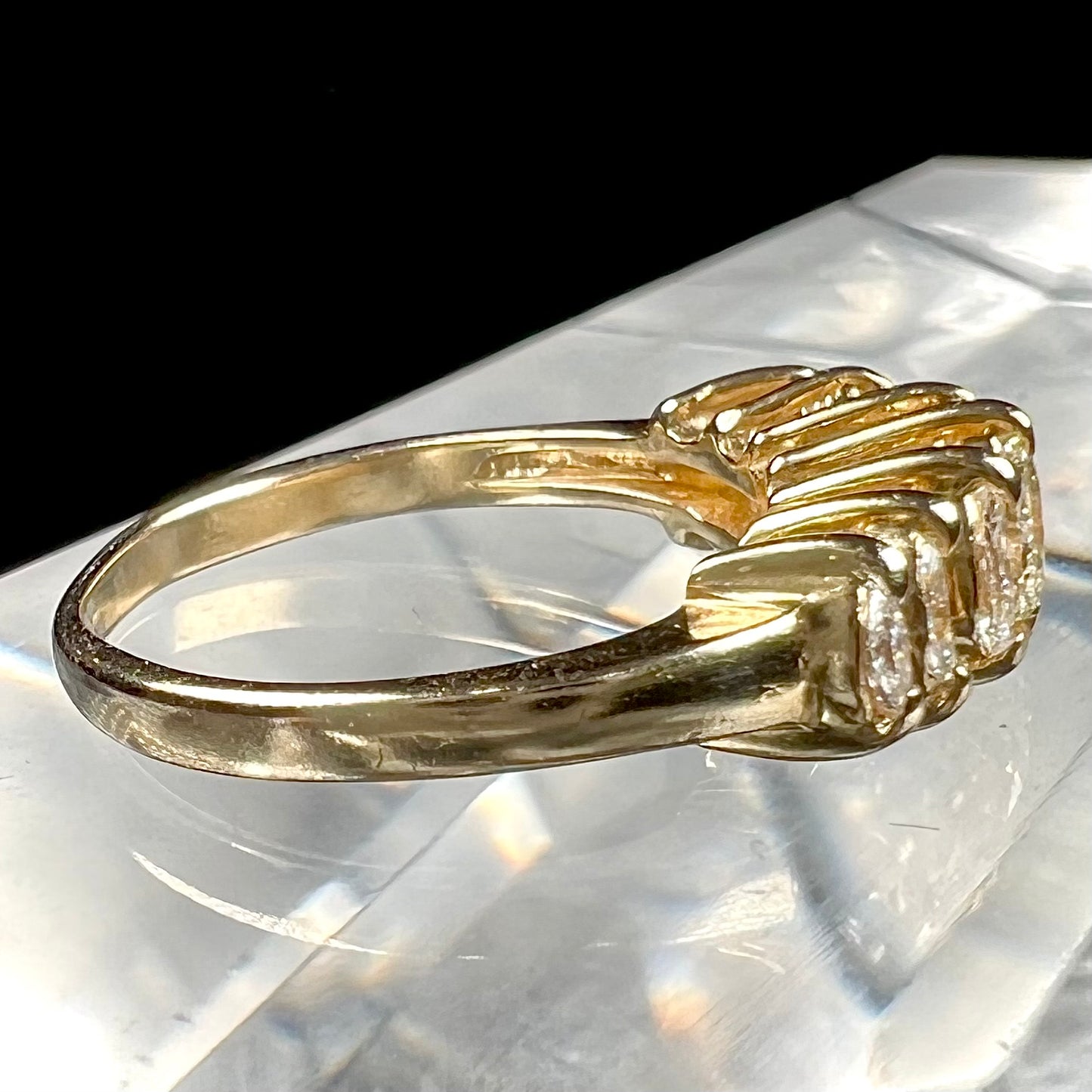 An estate yellow gold ring prong set with seven marquise cut diamonds.