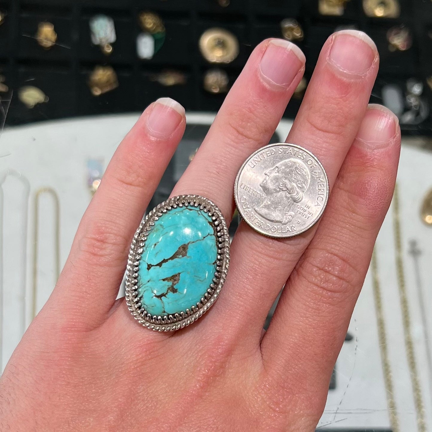 A sterling silver rope design ring set with a turquoise stone from Pilot Mountain Mine, Nevada.