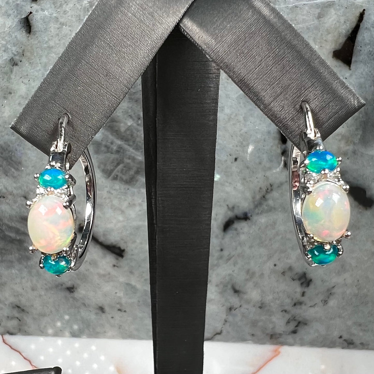 A sterling silver ring, earring, and necklace set made of Ethiopian opals and cubic zirconia.