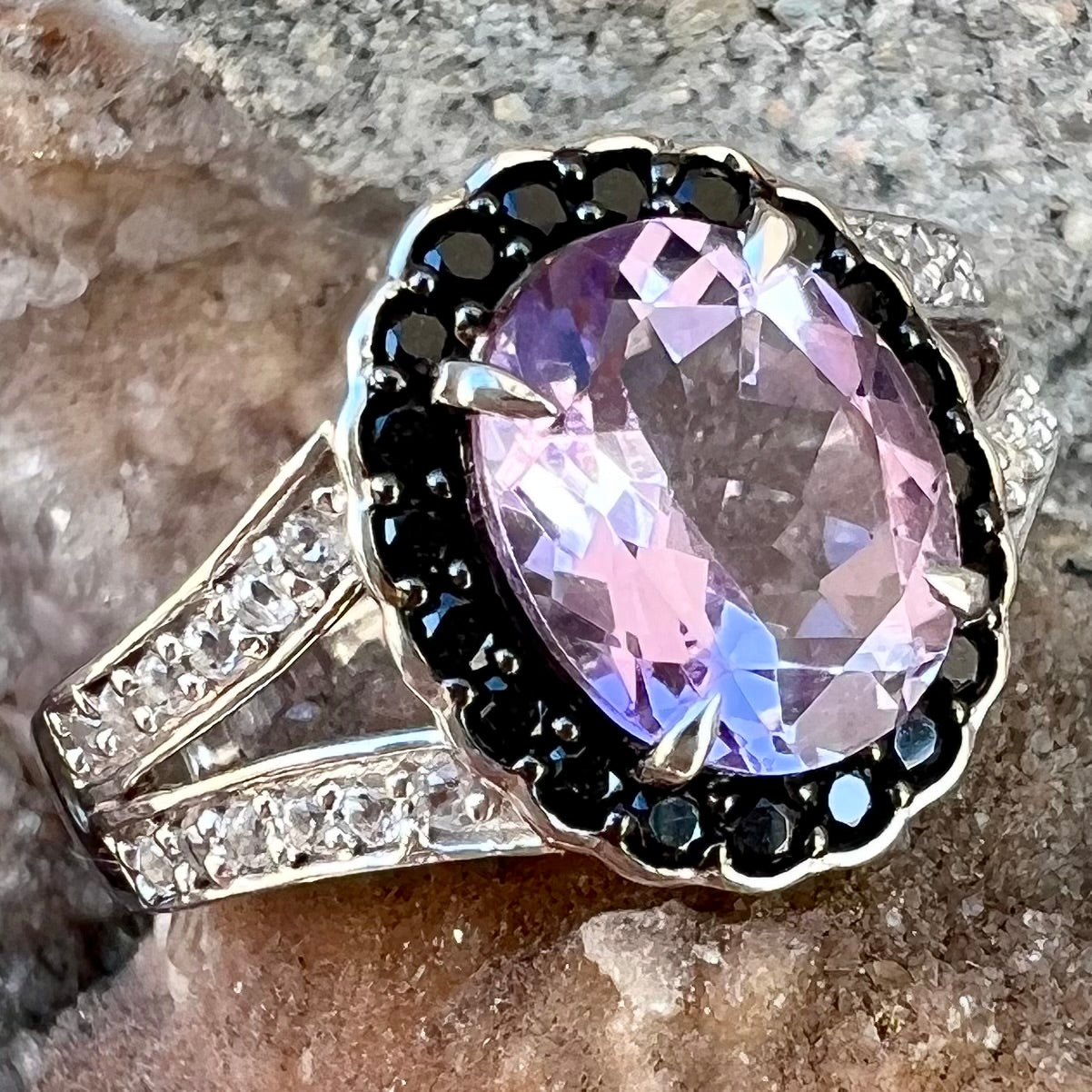 Sterling silver ladies' ring made with Rose de France amethyst set in a black spinel halo with white topaz accents.