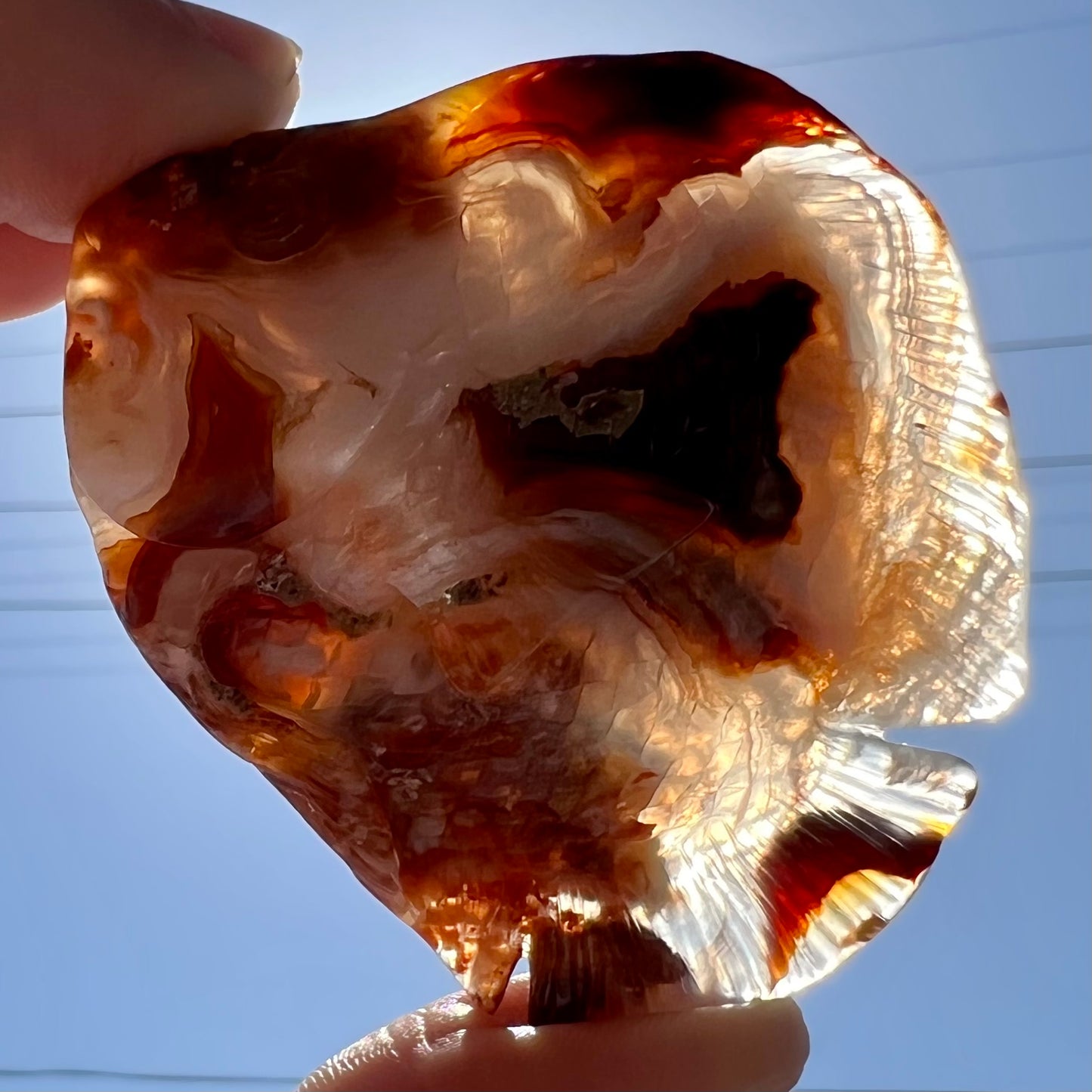 A stone fish carved from Northern Mexican fire agate. The material is brown and white.
