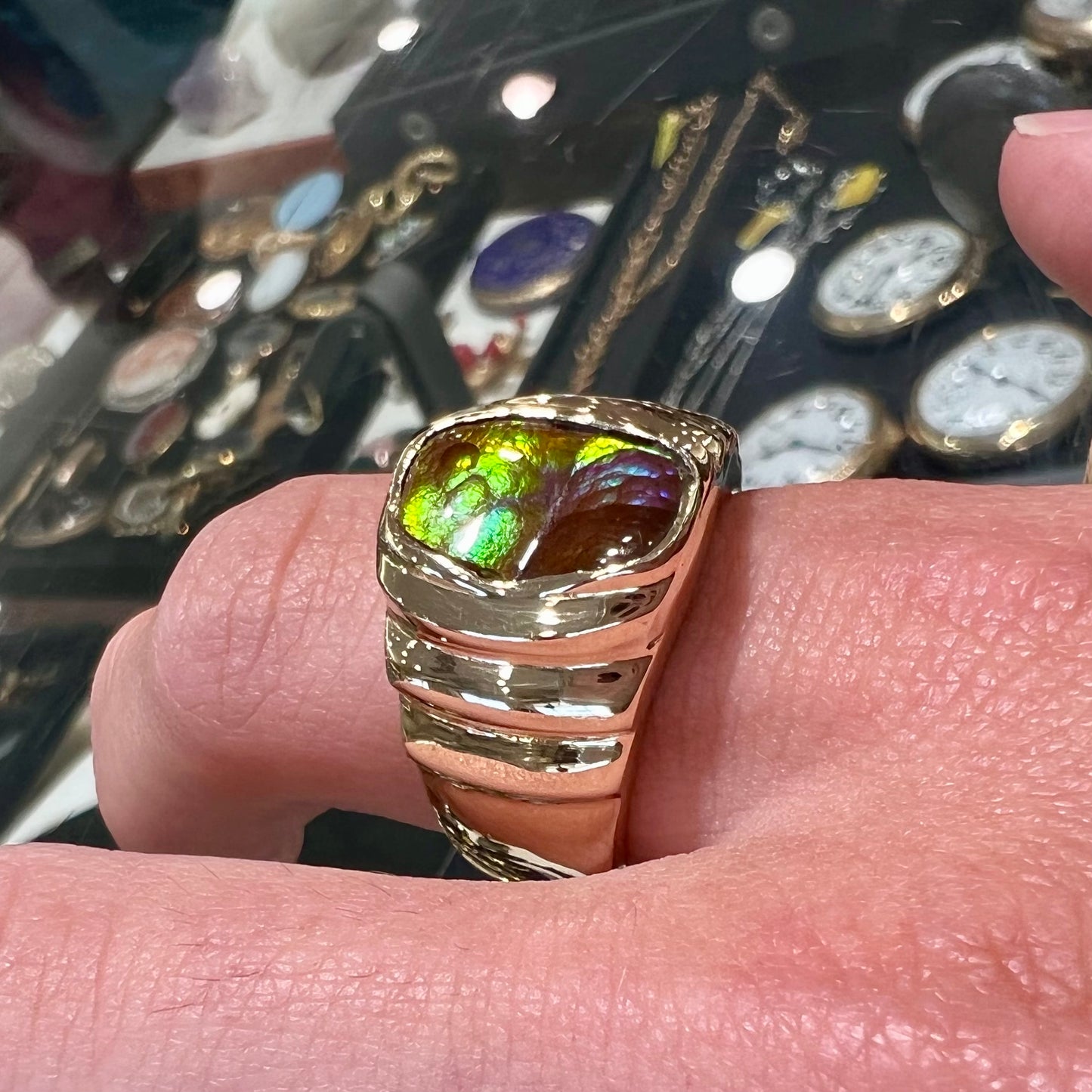 Men's fire agate solitaire ring cast in yellow gold. The ring is a step design.