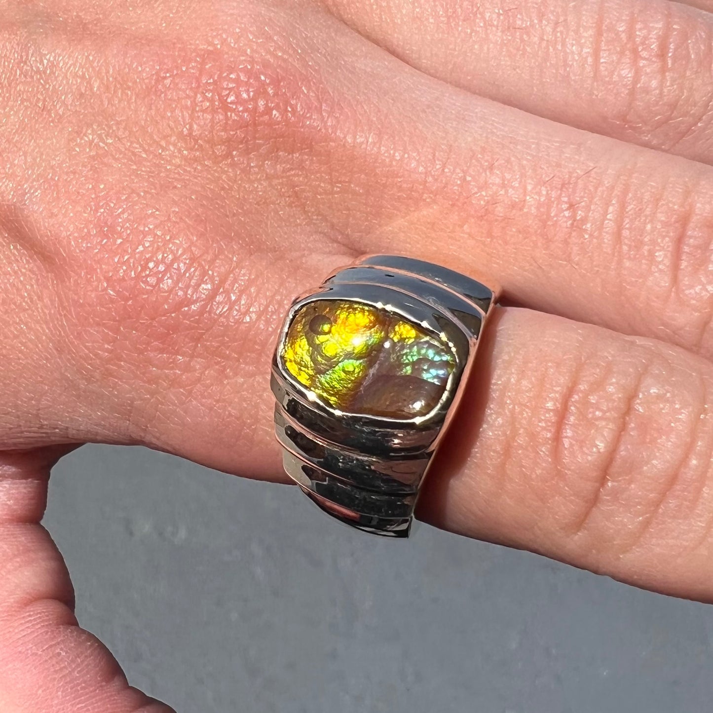 Men's fire agate solitaire ring cast in yellow gold. The ring is a step design.