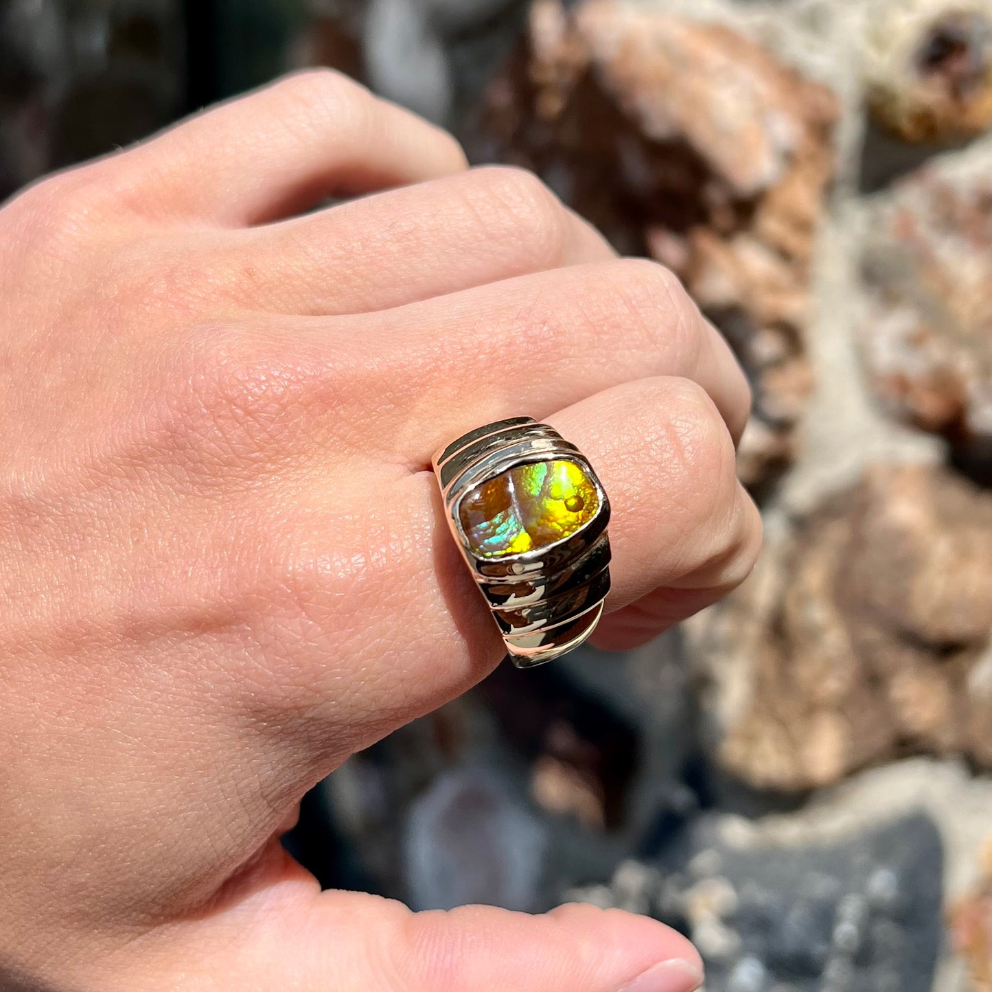 Men's fire agate solitaire ring cast in yellow gold. The ring is a step design.