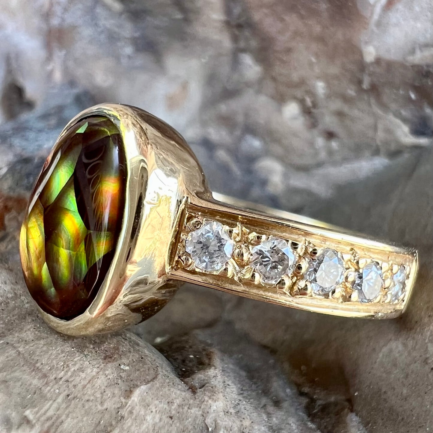 A ladies' gold fire agate and diamond engagement ring.