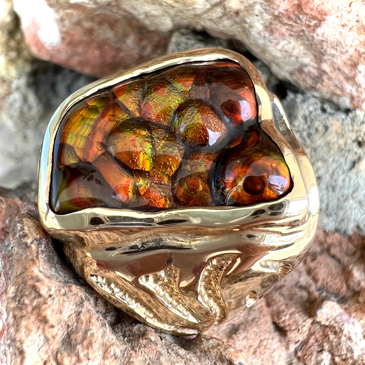 A men's custom fire agate solitaire ring cast in yellow gold.