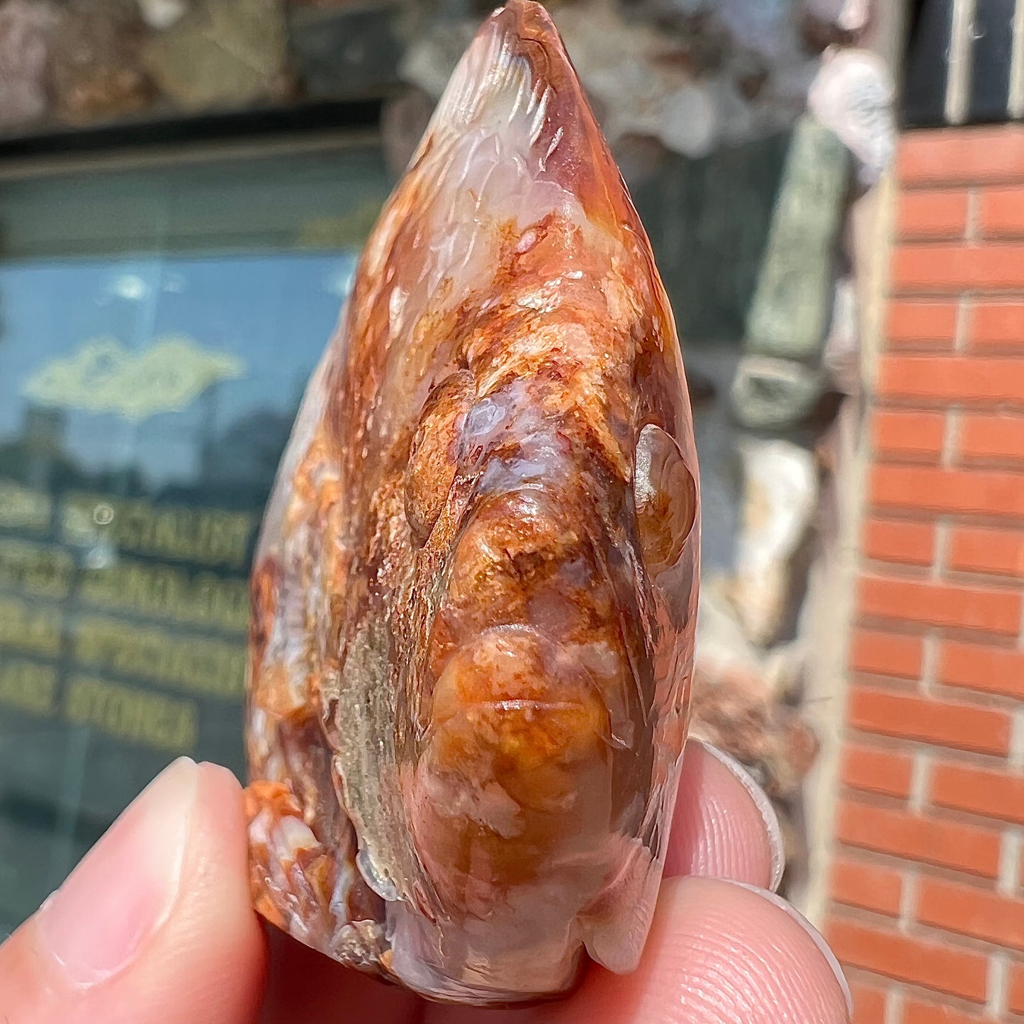 A stone fish carved from Northern Mexican fire agate. The material is brown and white.