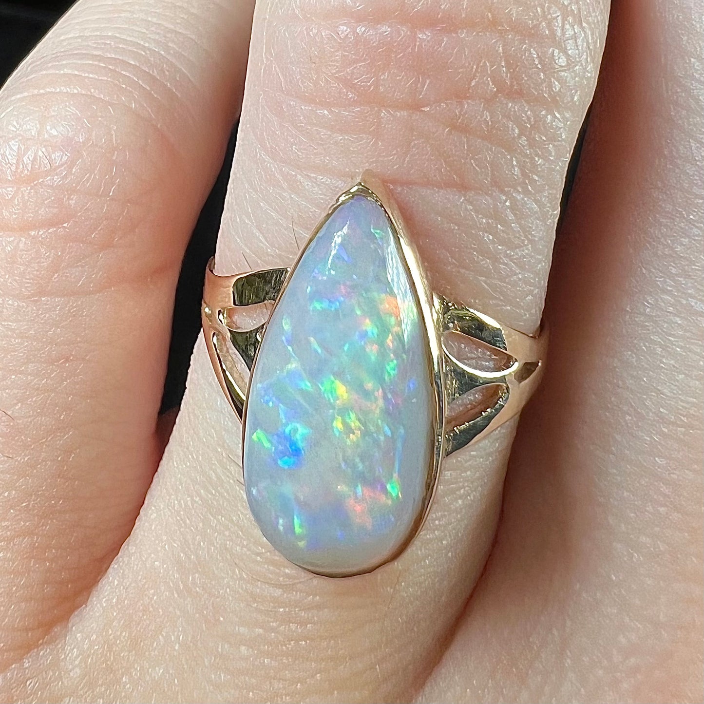 A ladies' pear shaped white crystal opal solitaire ring handmade in yellow gold.