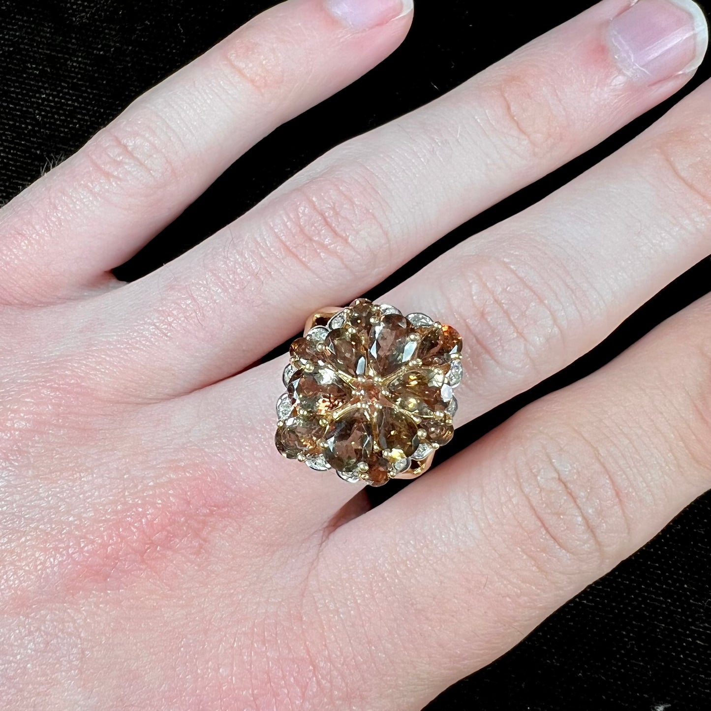A yellow gold andalusite and diamond cluster ring.
