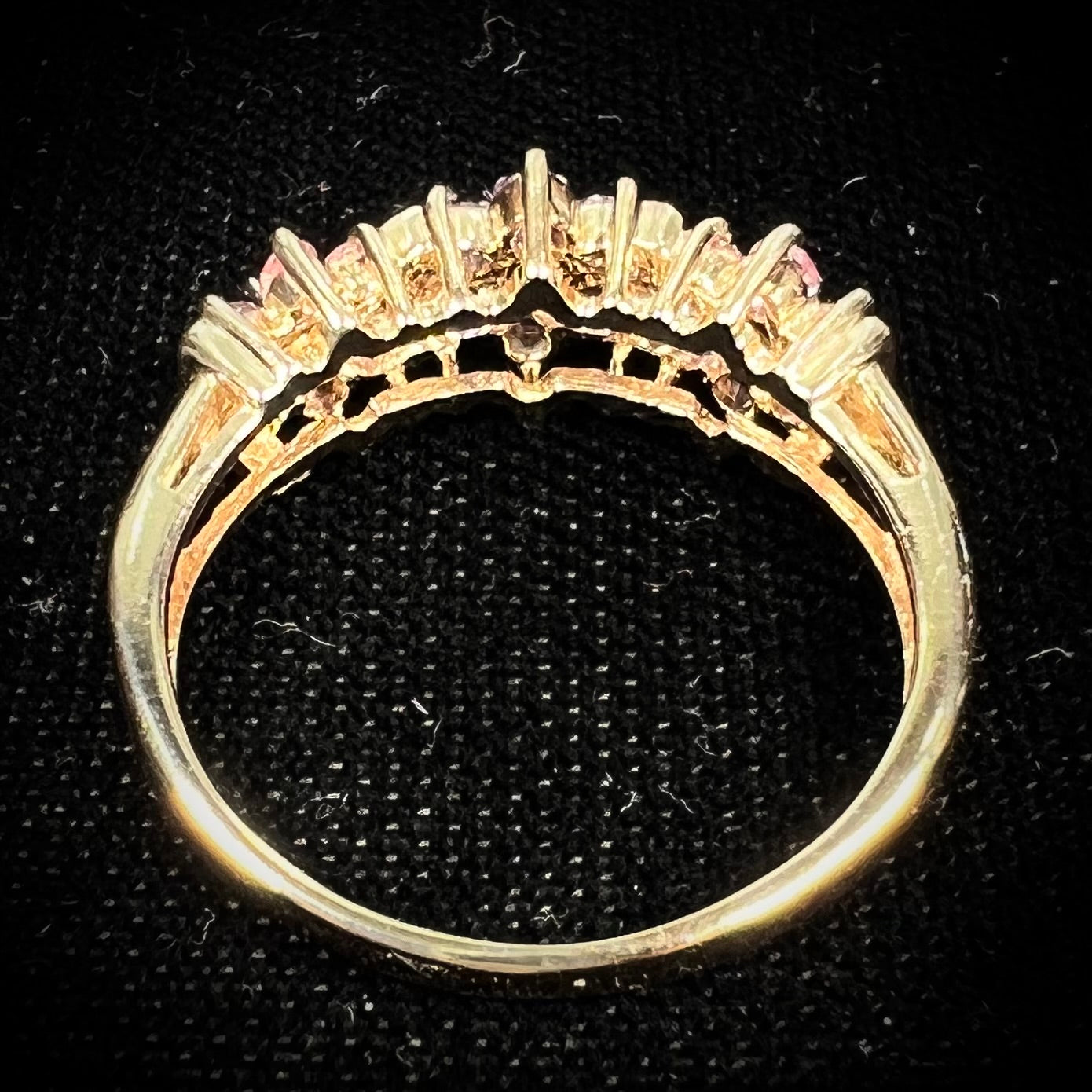 A vintage ladies' flower ring set with set with amethyst and pink tourmaline petals with a diamond center stone.