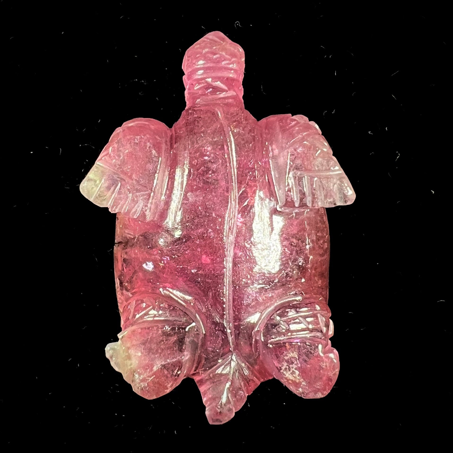 A crystal turtle carved from a pink tourmaline stone.