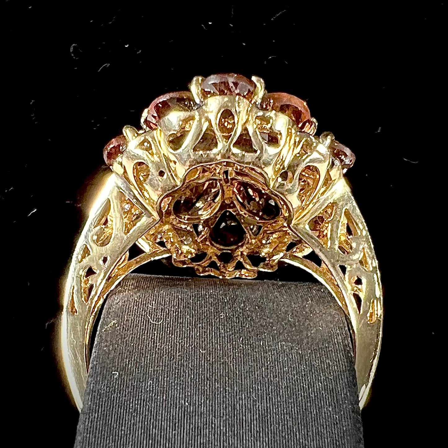 A yellow gold andalusite and diamond cluster ring.