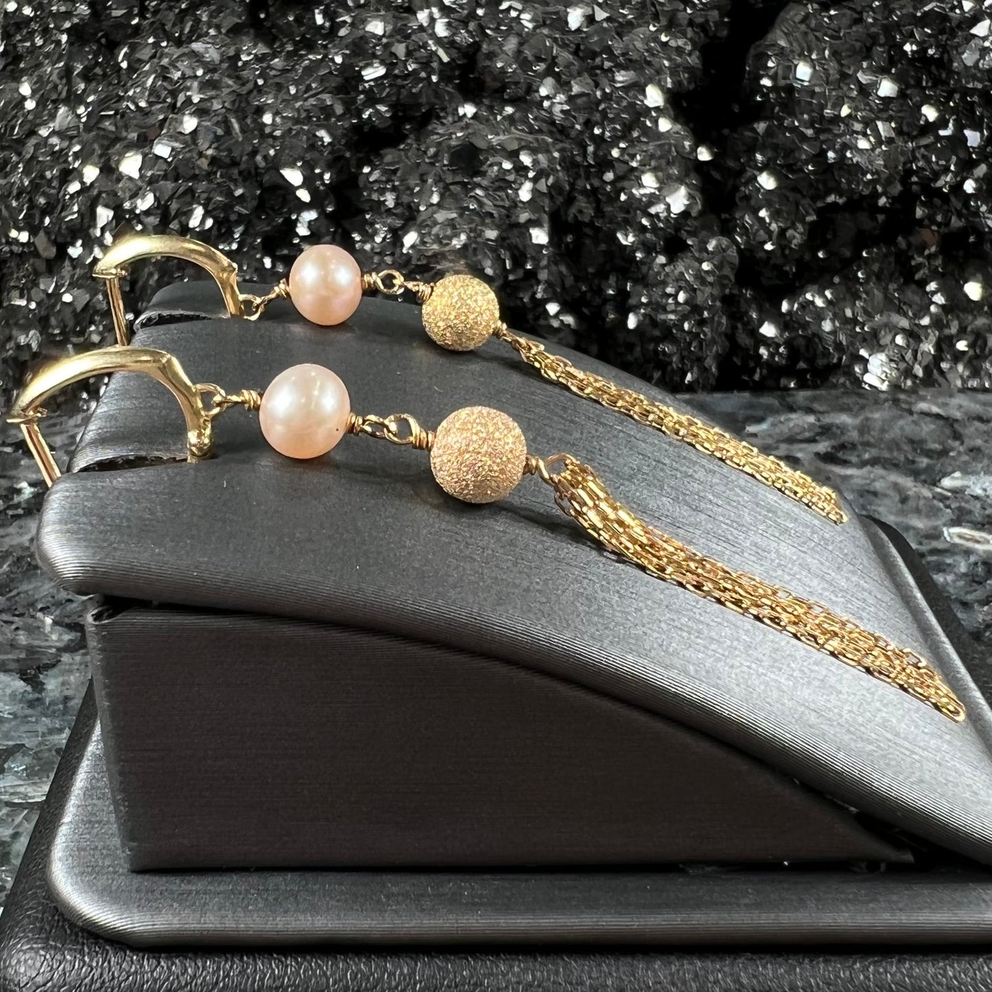 A pair of yellow gold and pink pearl dangle earrings.