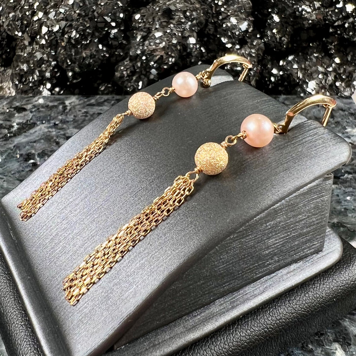 A pair of yellow gold and pink pearl dangle earrings.