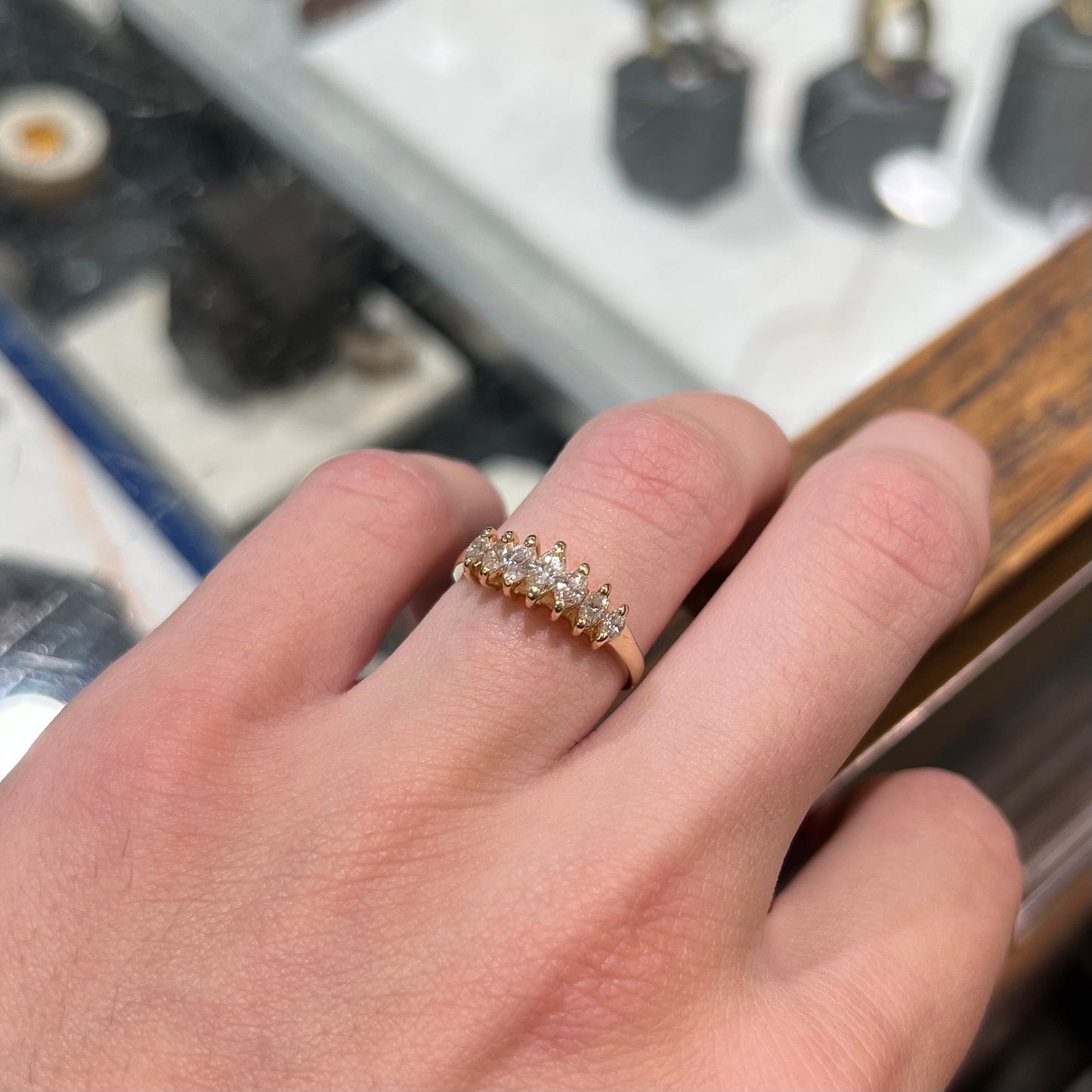 An estate yellow gold ring prong set with seven marquise cut diamonds.