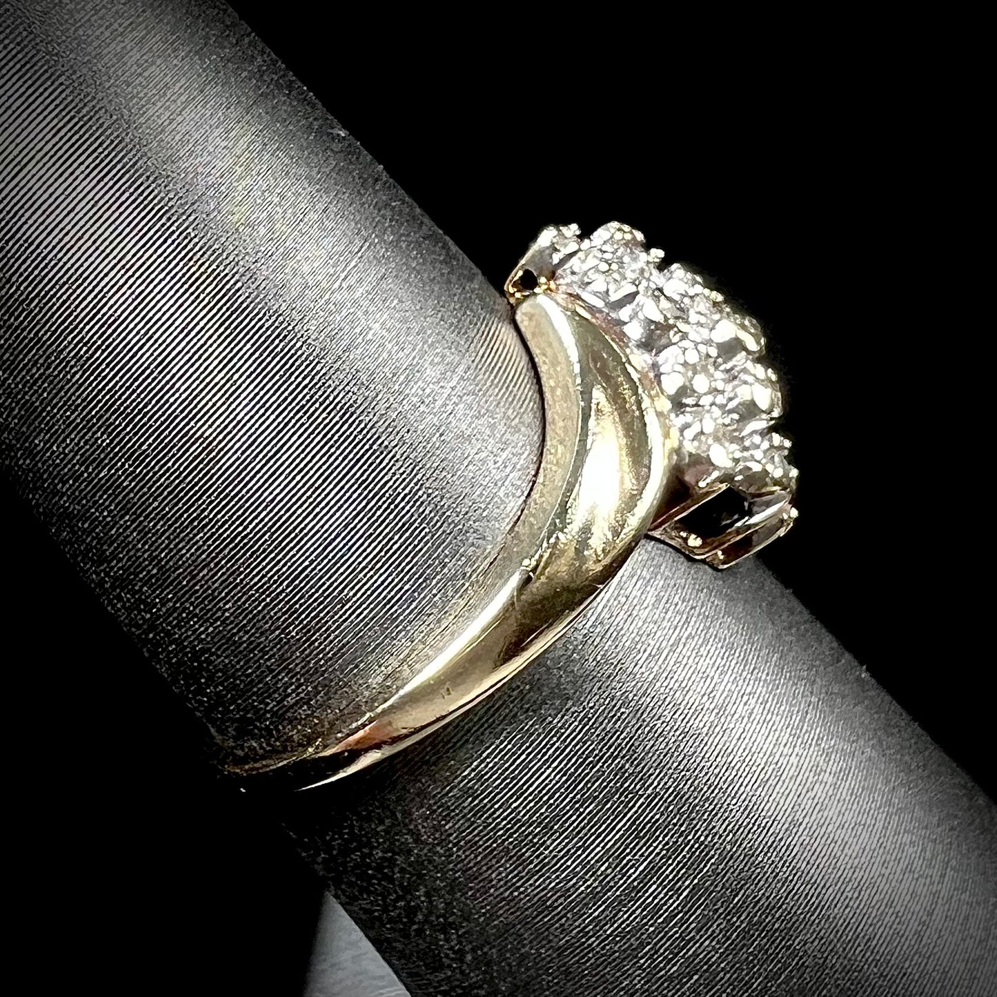 A ladies' estate yellow gold diamond cluster ring. The diamonds are round single cuts.