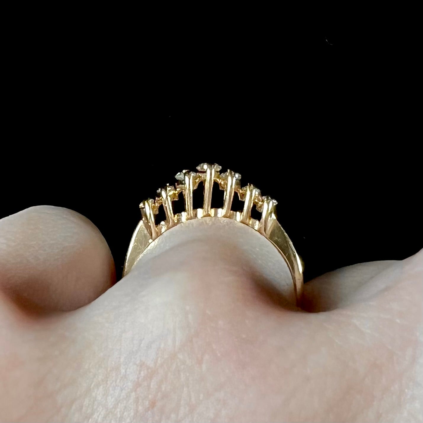 An estate yellow gold ring prong set with seven marquise cut diamonds.
