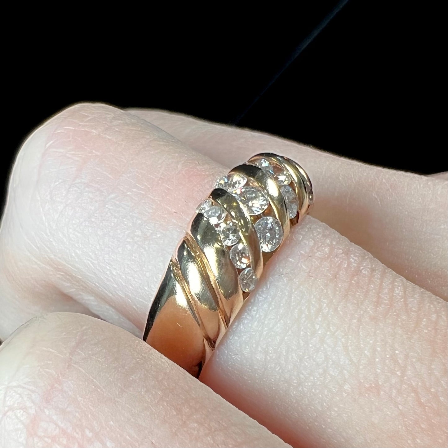 A ladies' channel set gold diamond ring.