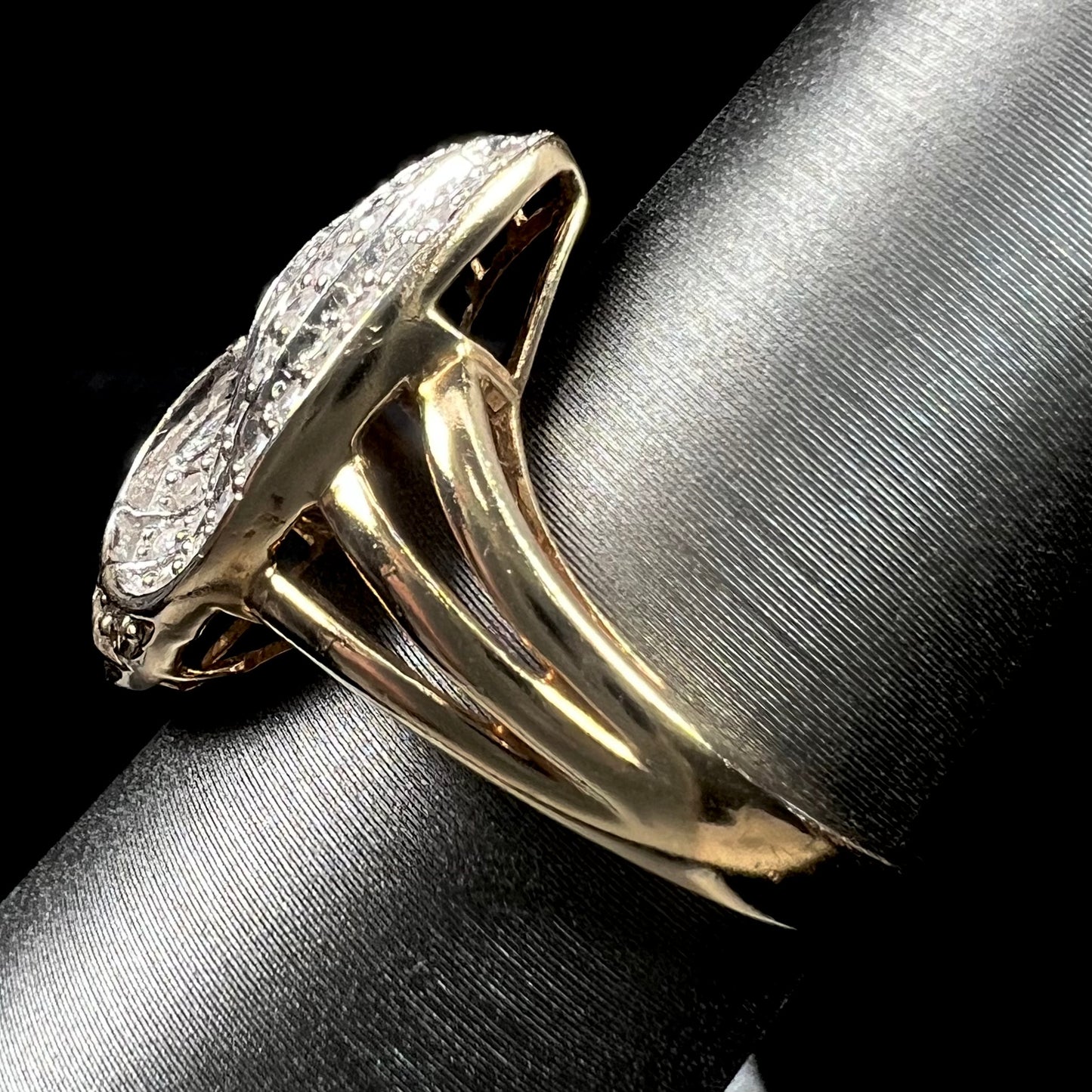 A ladies' 10 karat yellow gold split shank ring pave set with white and champagne colored diamonds.