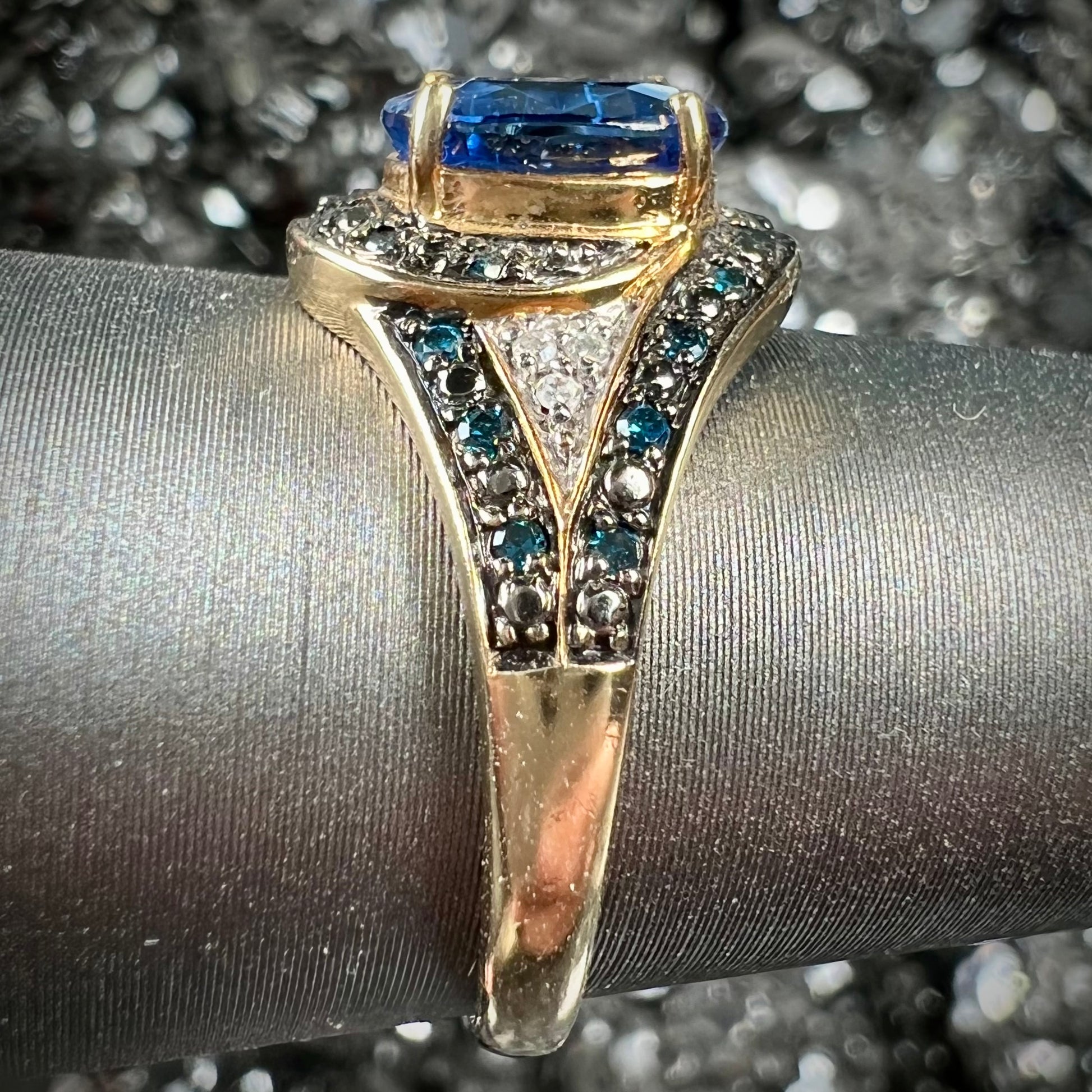 A ladies' oval cut blue kyanite twist ring pave set with blue and white diamond accents.