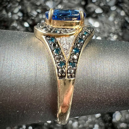 A ladies' oval cut blue kyanite twist ring pave set with blue and white diamond accents.