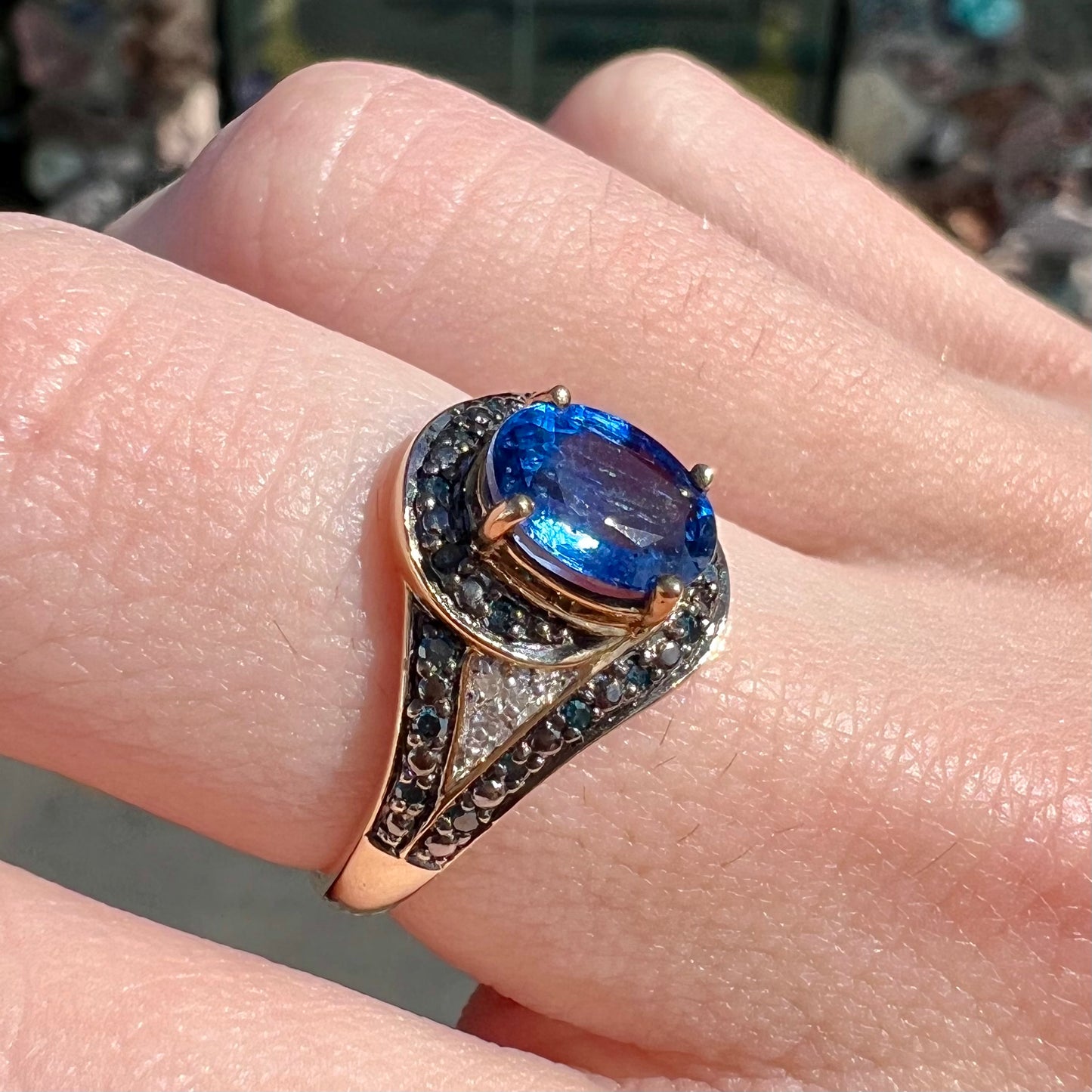 A ladies' oval cut blue kyanite twist ring pave set with blue and white diamond accents.