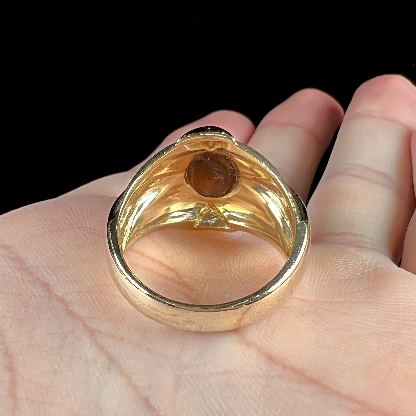 A men's brushed yellow gold fire agate ring with polished accents.