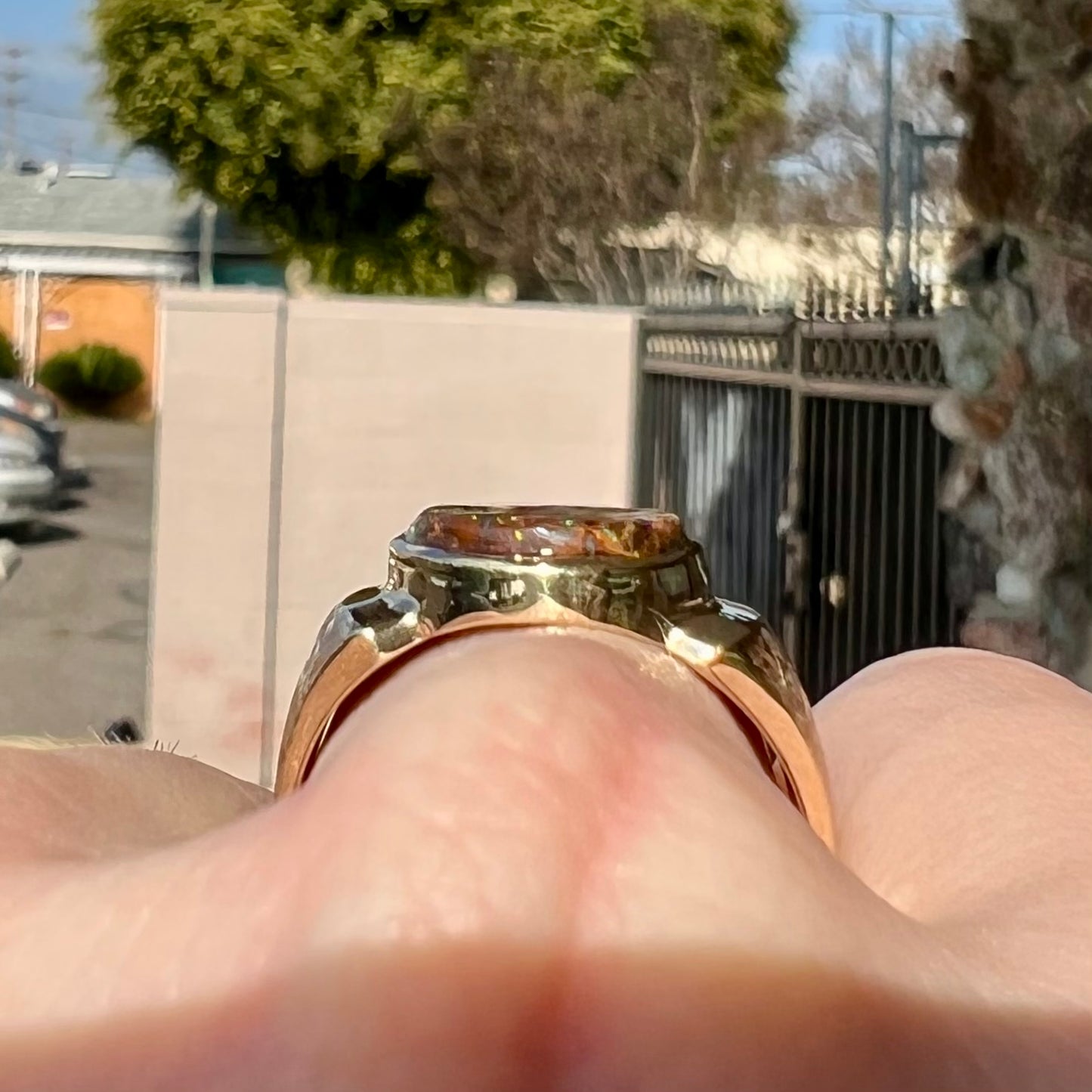 A Koroit boulder opal men's ring in brushed yellow gold.