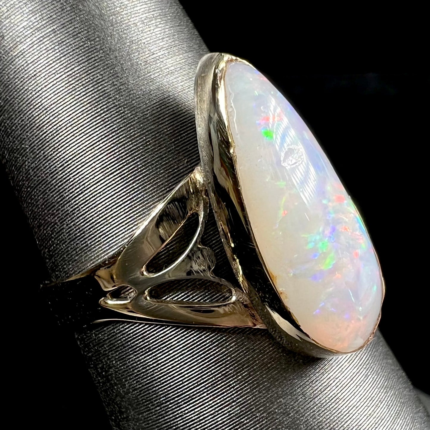 A ladies' pear shaped white crystal opal solitaire ring handmade in yellow gold.