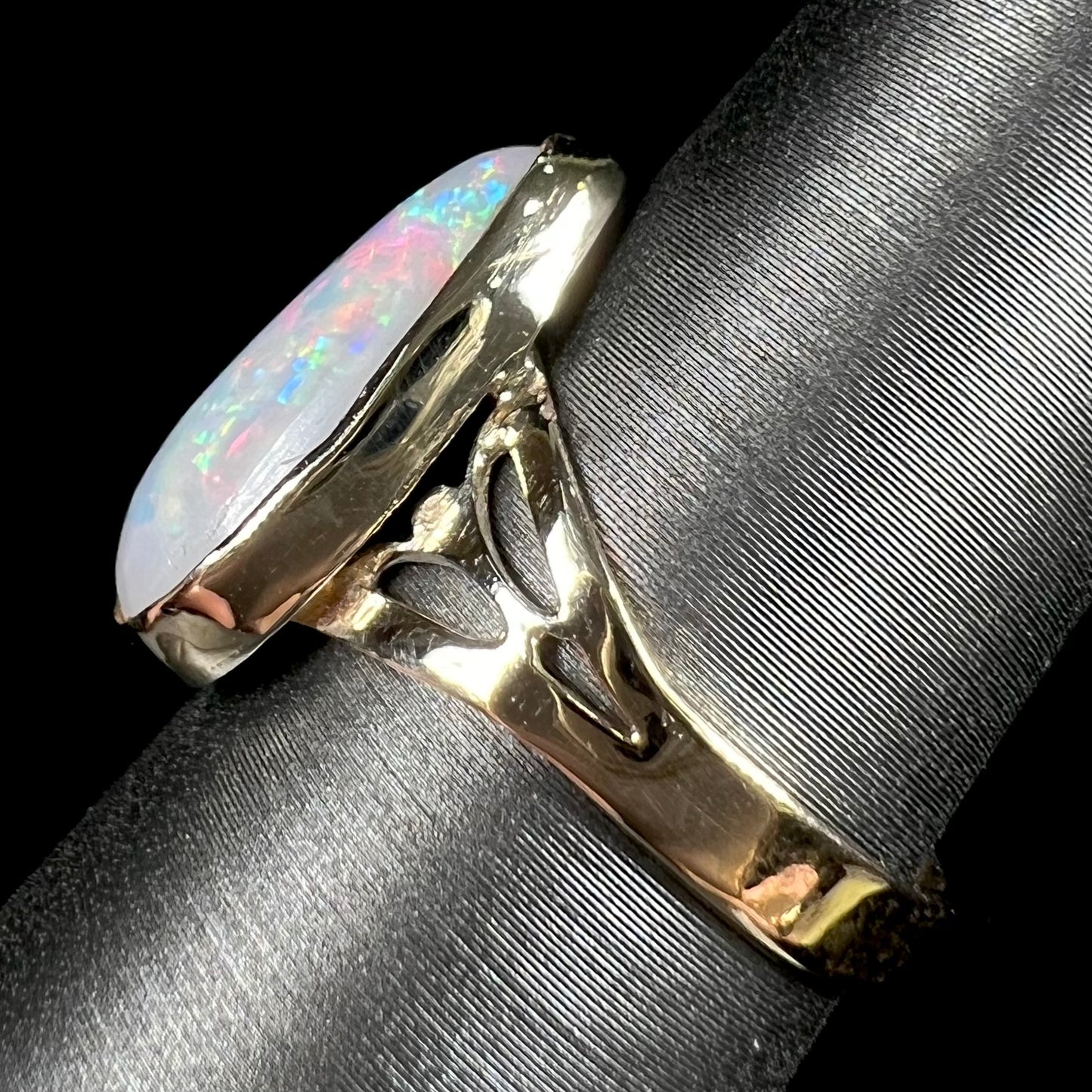 A ladies' pear shaped white crystal opal solitaire ring handmade in yellow gold.