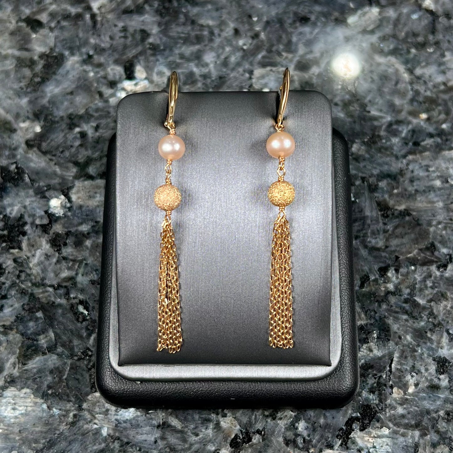 A pair of yellow gold and pink pearl dangle earrings.