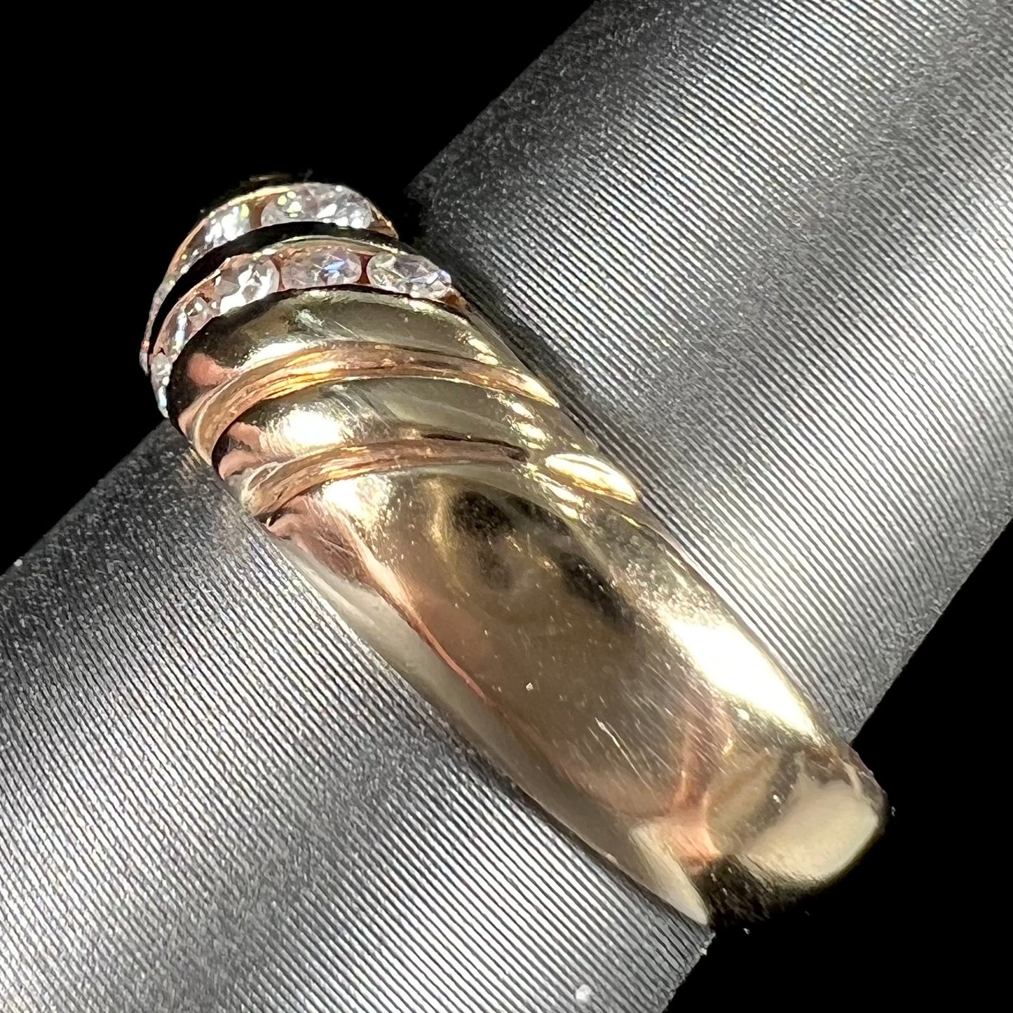 A ladies' channel set gold diamond ring.