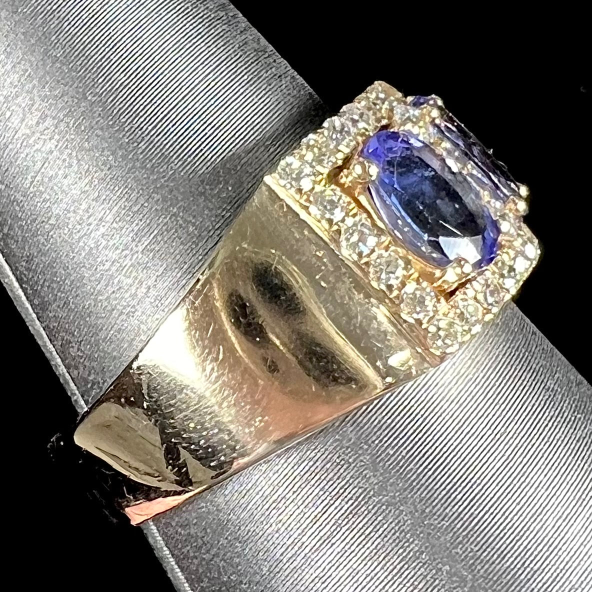 A gold and diamond ladies' band set with five oval cut tanzanite stones.