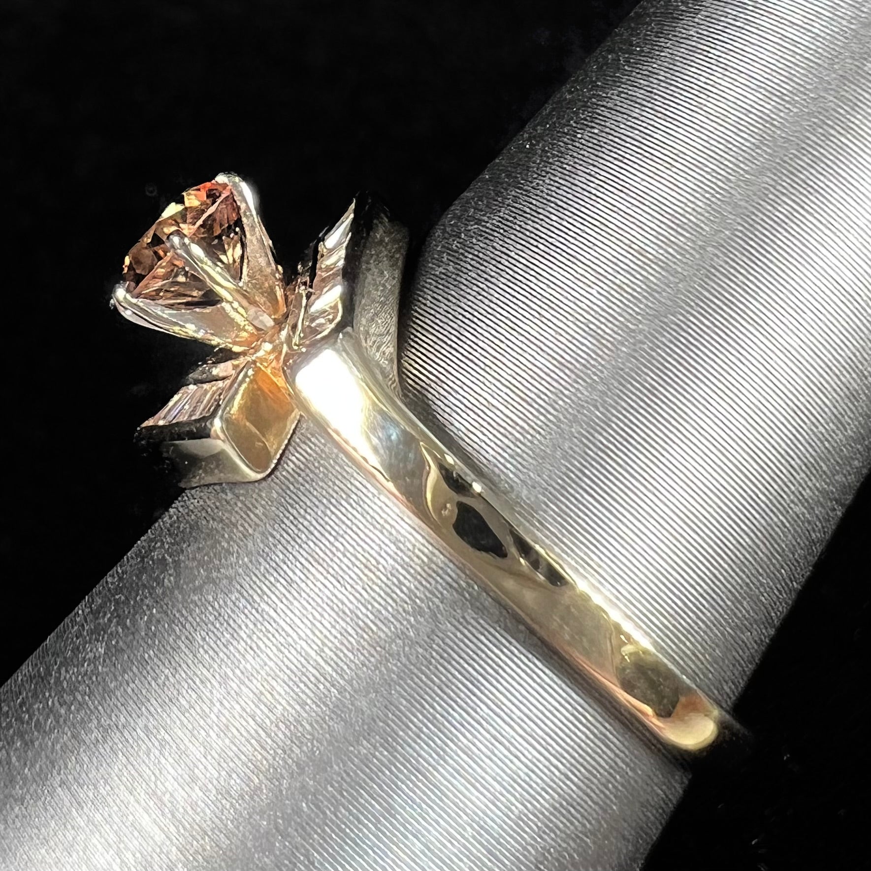 A yellow gold ladies' golden topaz ring set with baguette cut side diamonds.