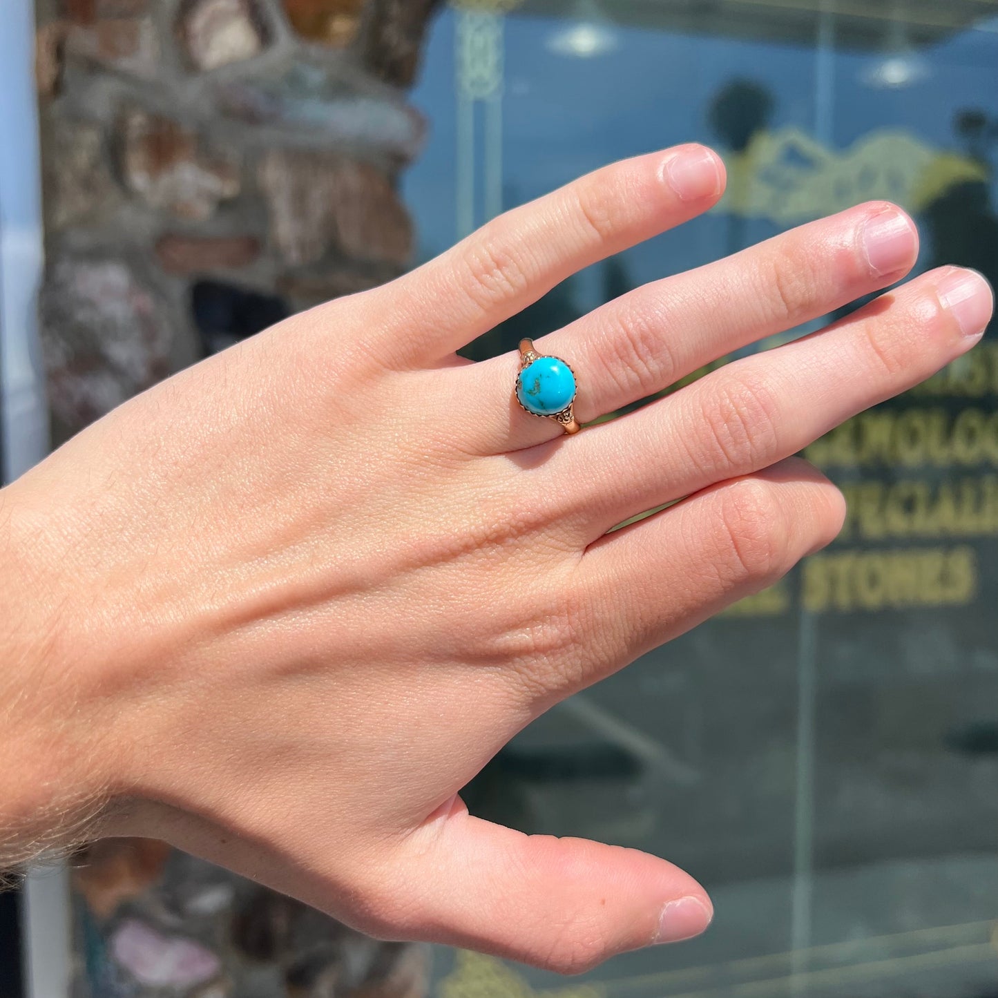 A ladies' yellow gold turquoise ring. The turquoise is a round cabochon cut.