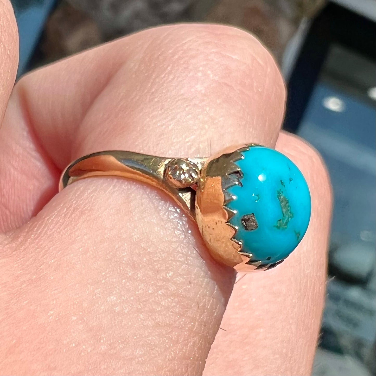 A ladies' yellow gold turquoise ring. The turquoise is a round cabochon cut.