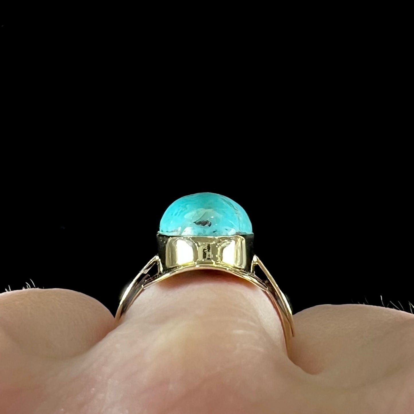 A Sleeping Beauty turquoise solitaire ring cast in 14kt yellow gold.