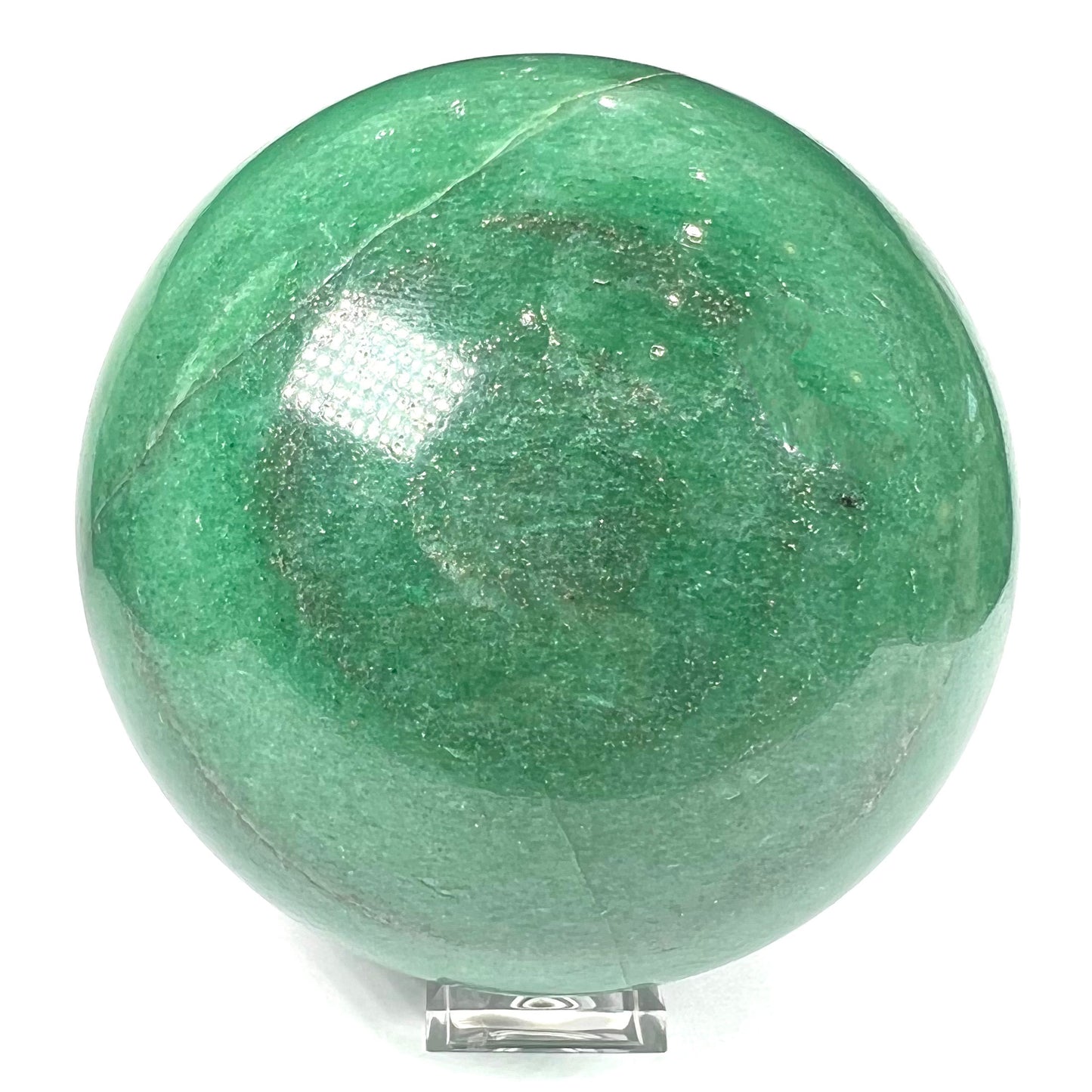 A stone sphere carved from natural green aventurine quartz with containing mica inclusions.