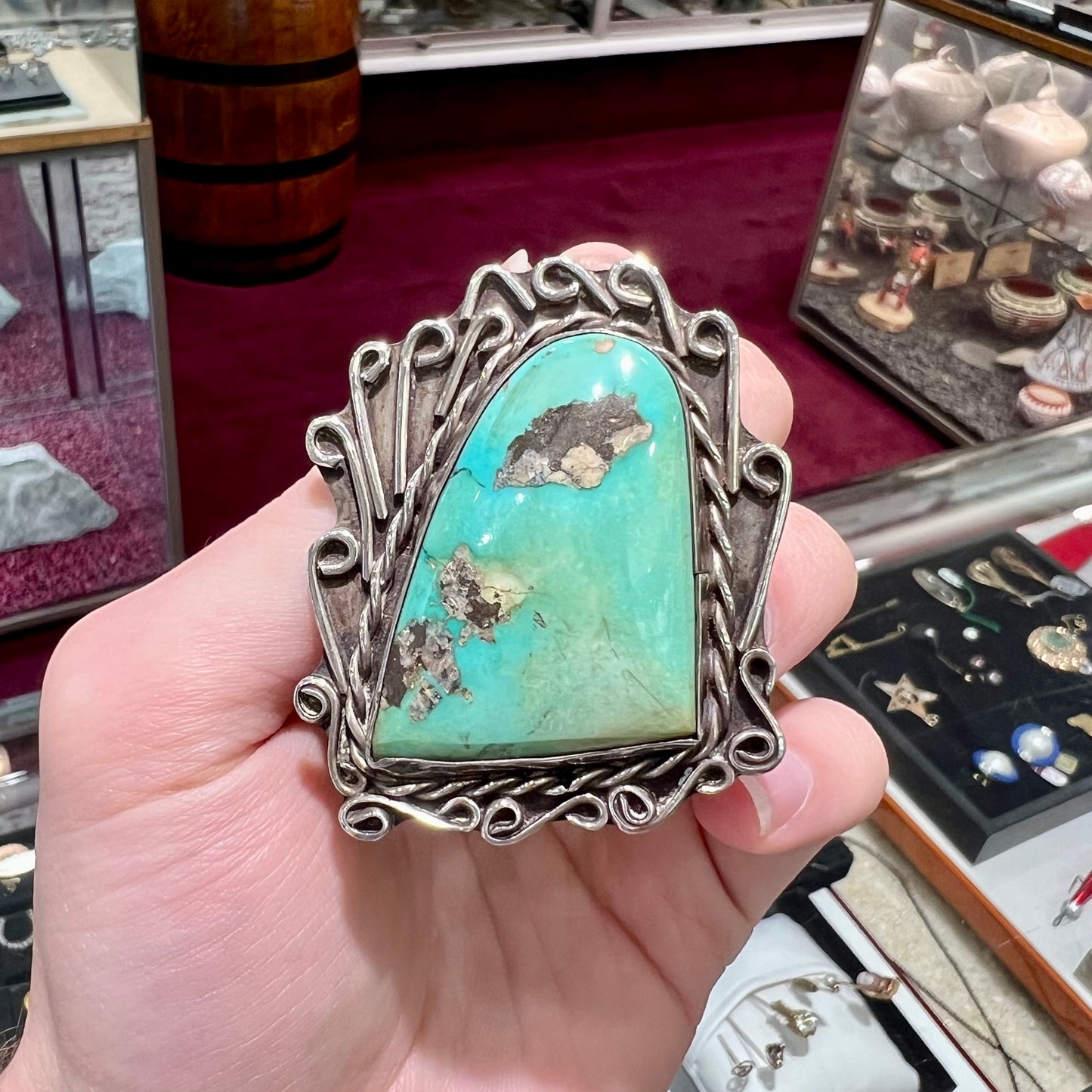 A sterling silver pendant made from greenish blue Royston turquoise, handmade by an unknown Hopi artist.