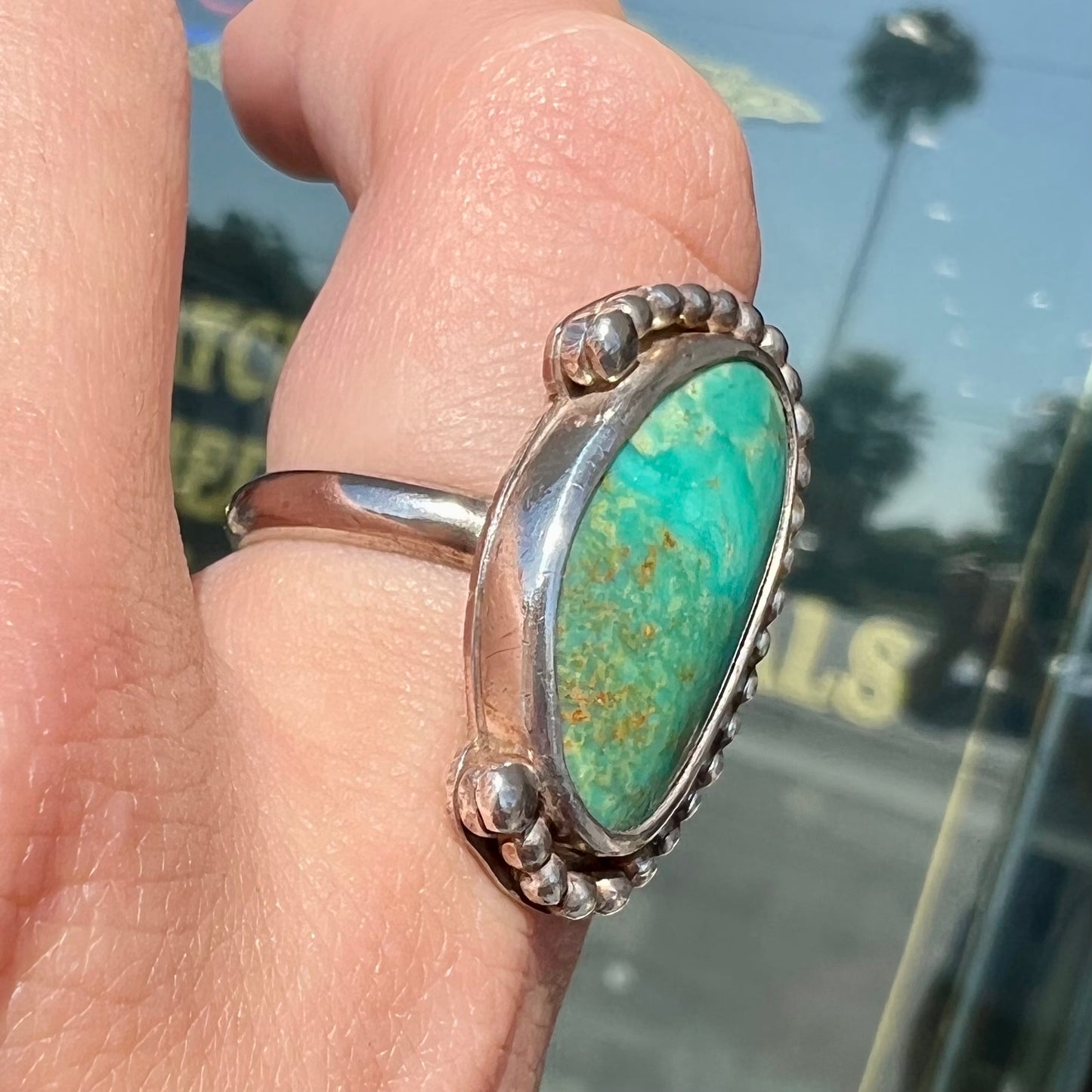 A sterling silver, Native American style green turquoise ring. The turquoise is from the Royston Mining District.