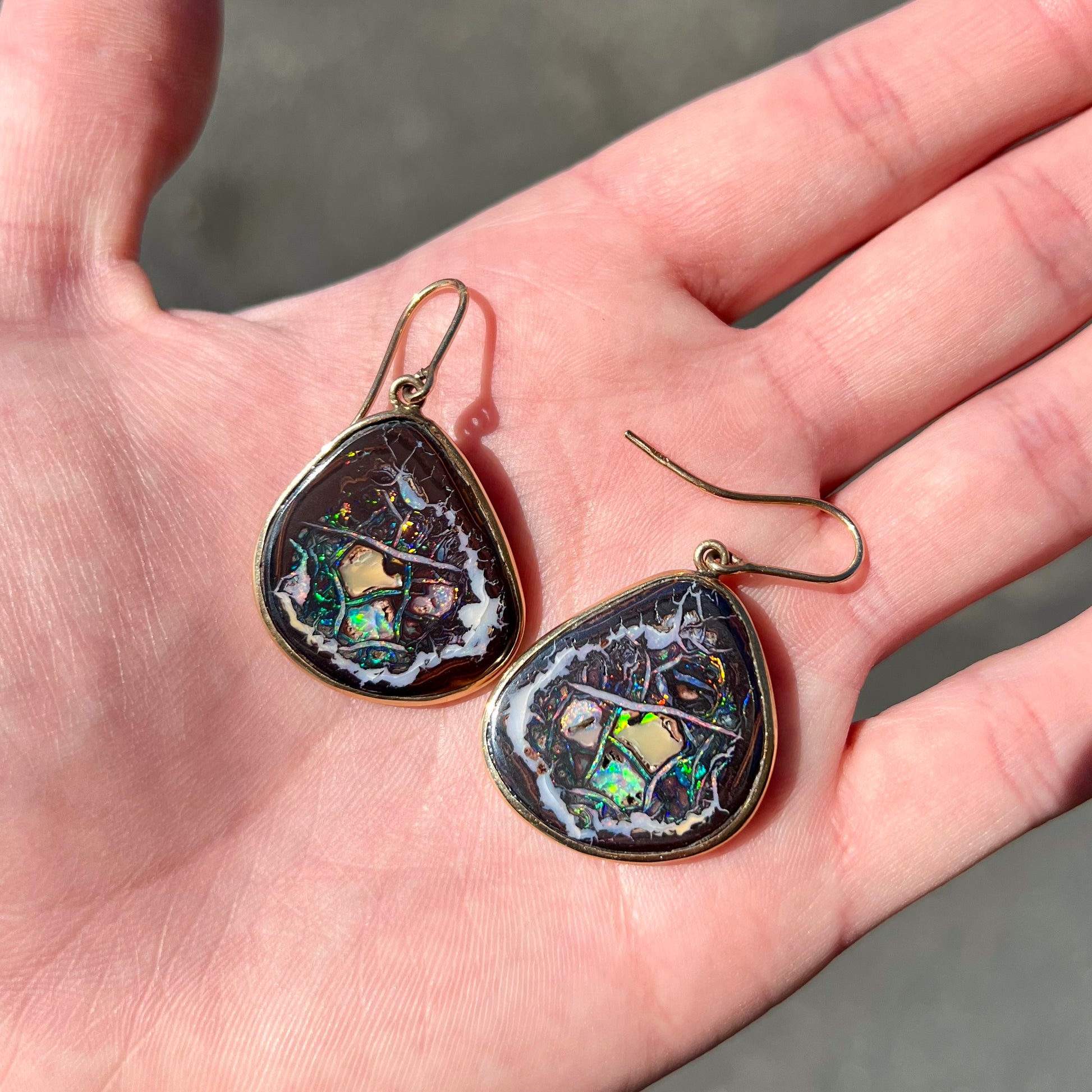 A pair of yellow gold bezel set Yowah nut boulder opal dangle earrings.