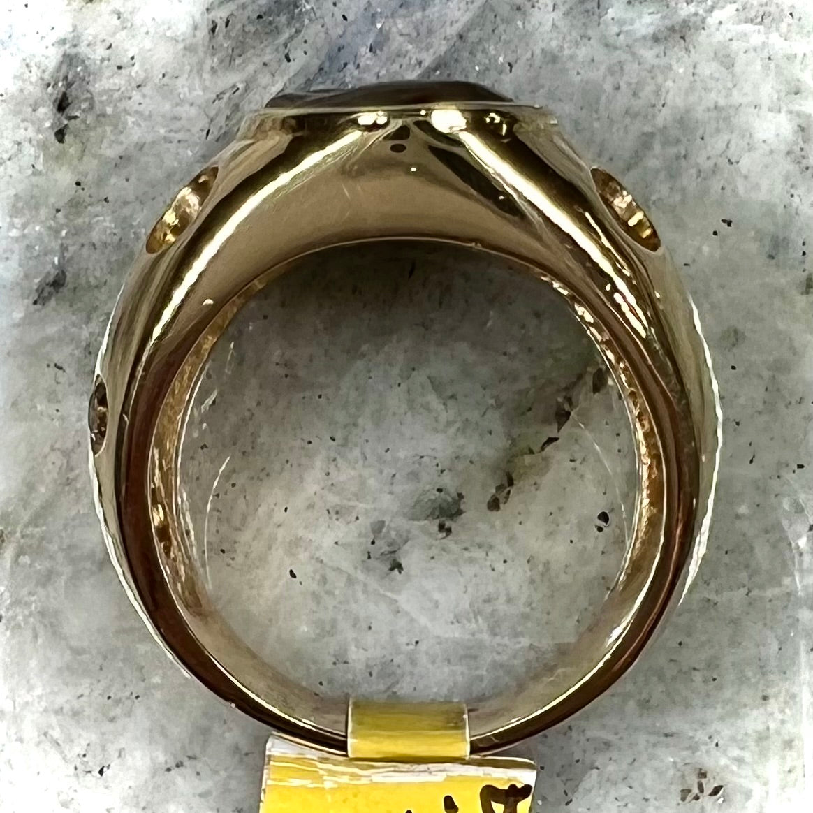 Men's rainbow fire agate ring set in yellow gold with champagne diamonds. The ring style has holes.