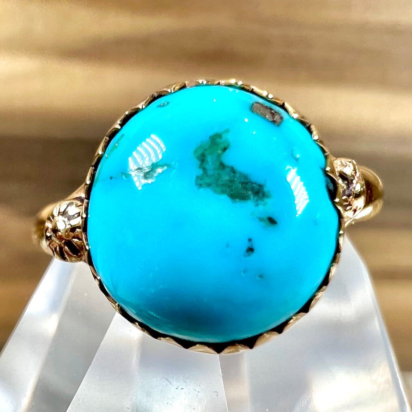 A ladies' yellow gold turquoise ring. The turquoise is a round cabochon cut.