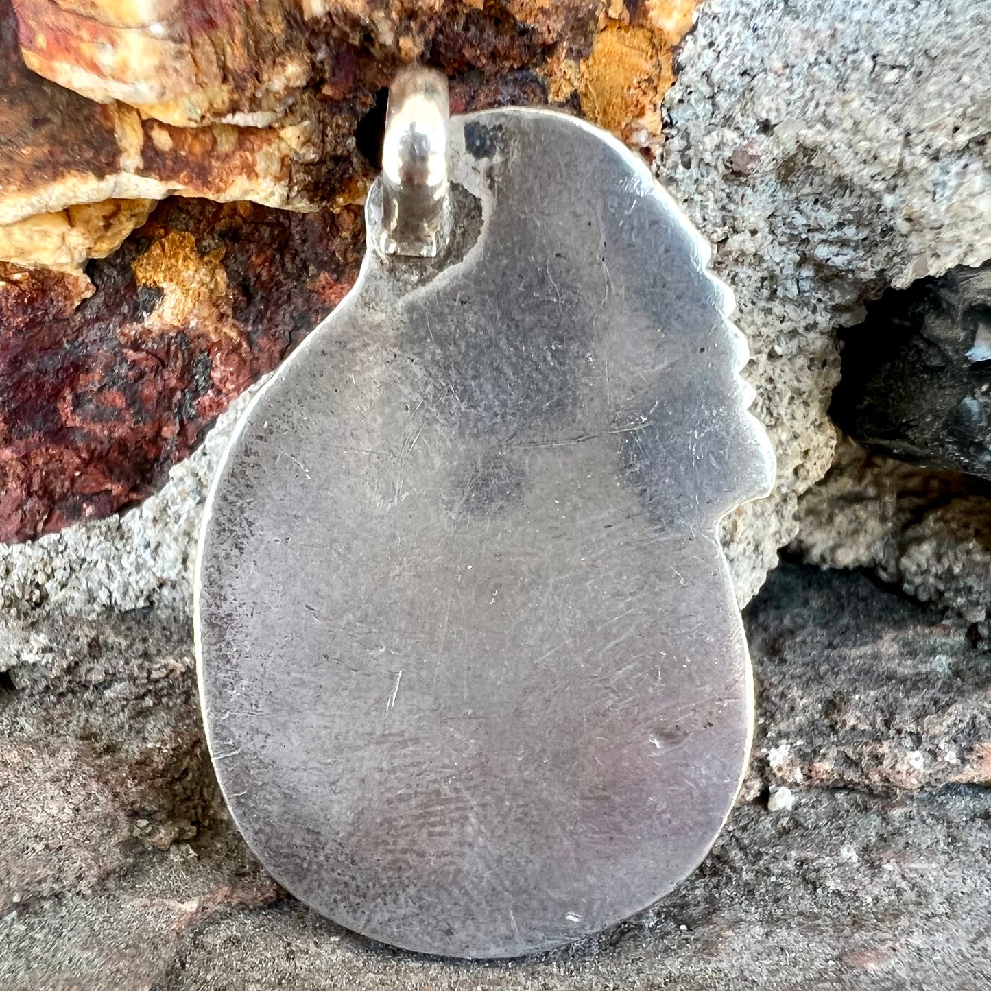 A handmade silver Navajo style pendant set with a turquoise stone from Kingman, Arizona.