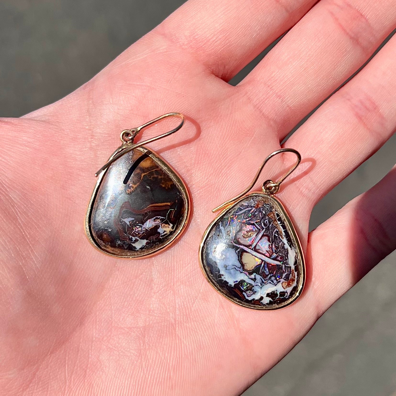 A pair of yellow gold bezel set Yowah nut boulder opal dangle earrings.
